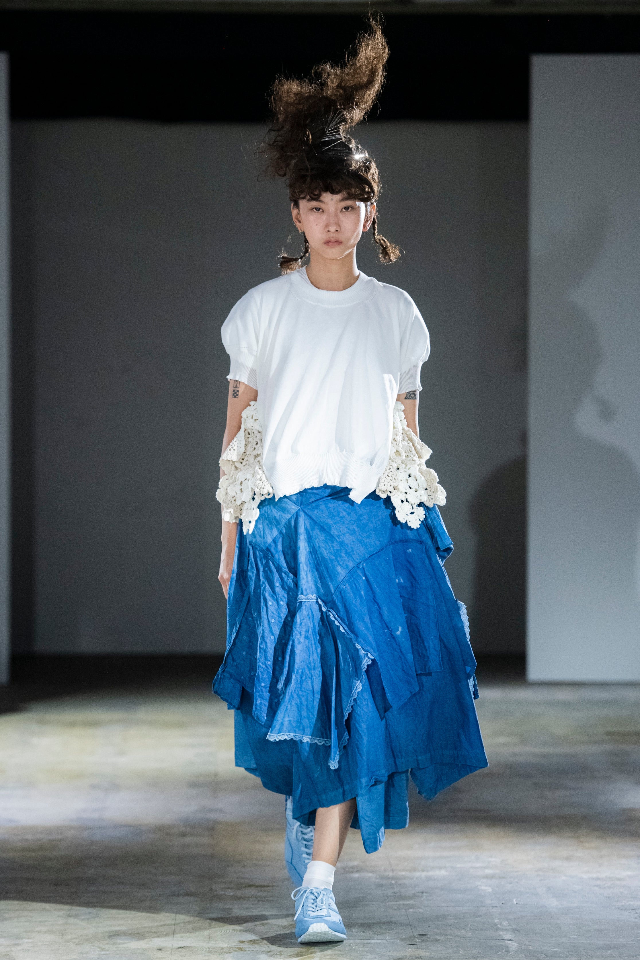 Fashion model wearing a tao SS24 outfit
