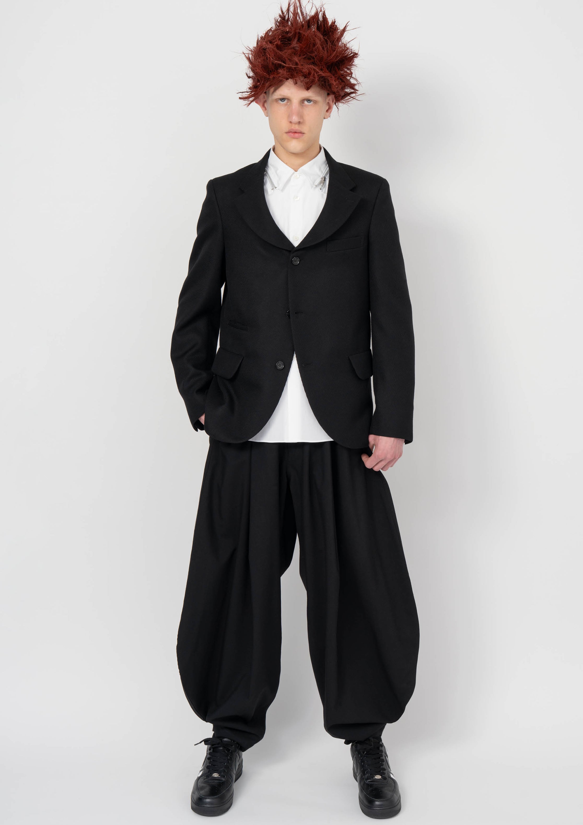 Fashion model wearing a BLACK COMME DES GARÇONS AW26 outfit
