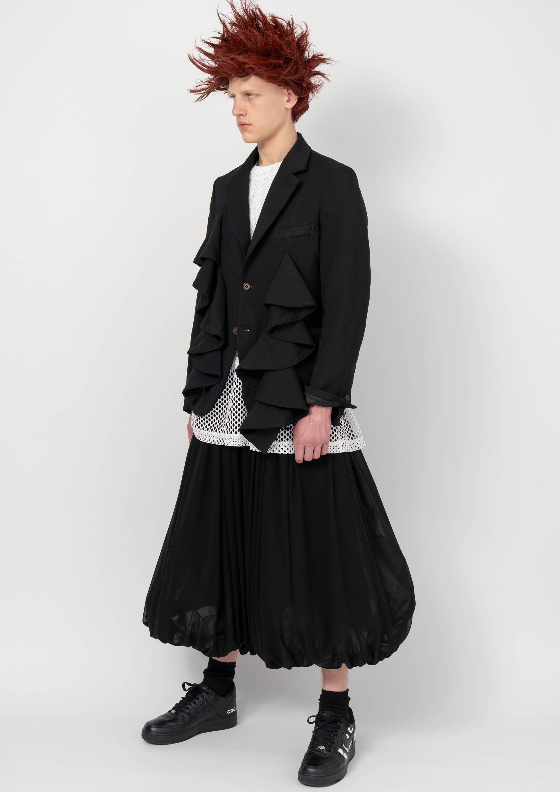 Fashion model wearing a BLACK COMME DES GARÇONS AW26 outfit