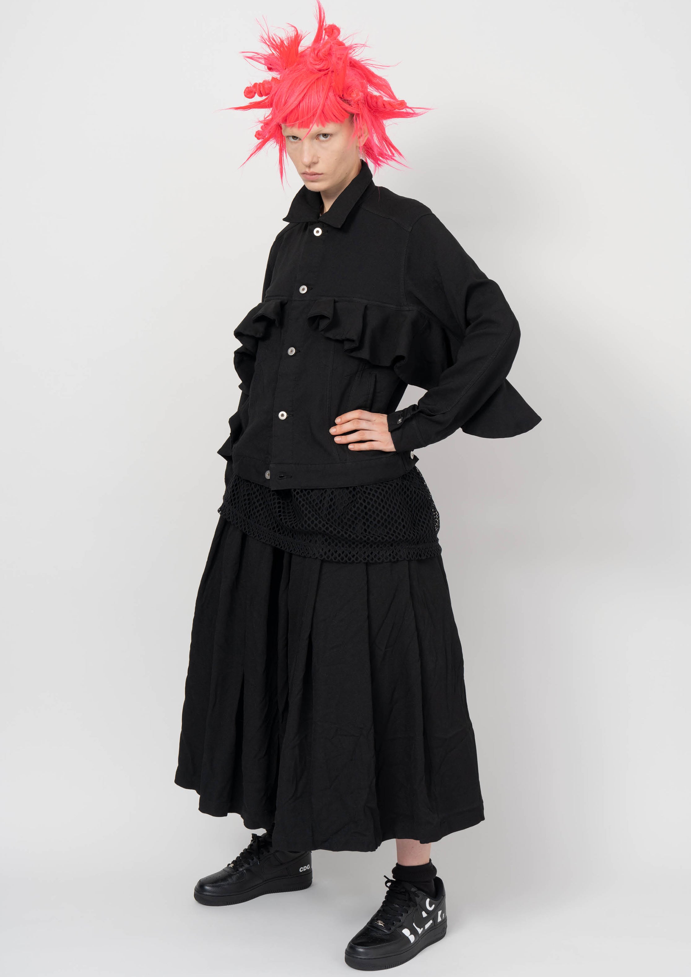 Fashion model wearing a BLACK COMME DES GARÇONS AW26 outfit