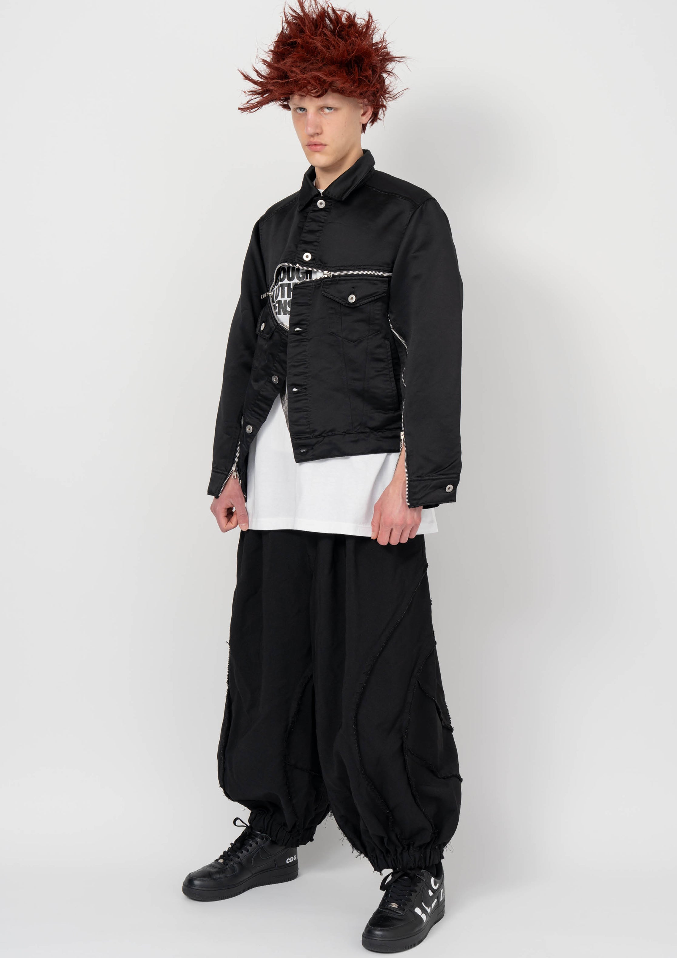 Fashion model wearing a BLACK COMME DES GARÇONS AW26 outfit