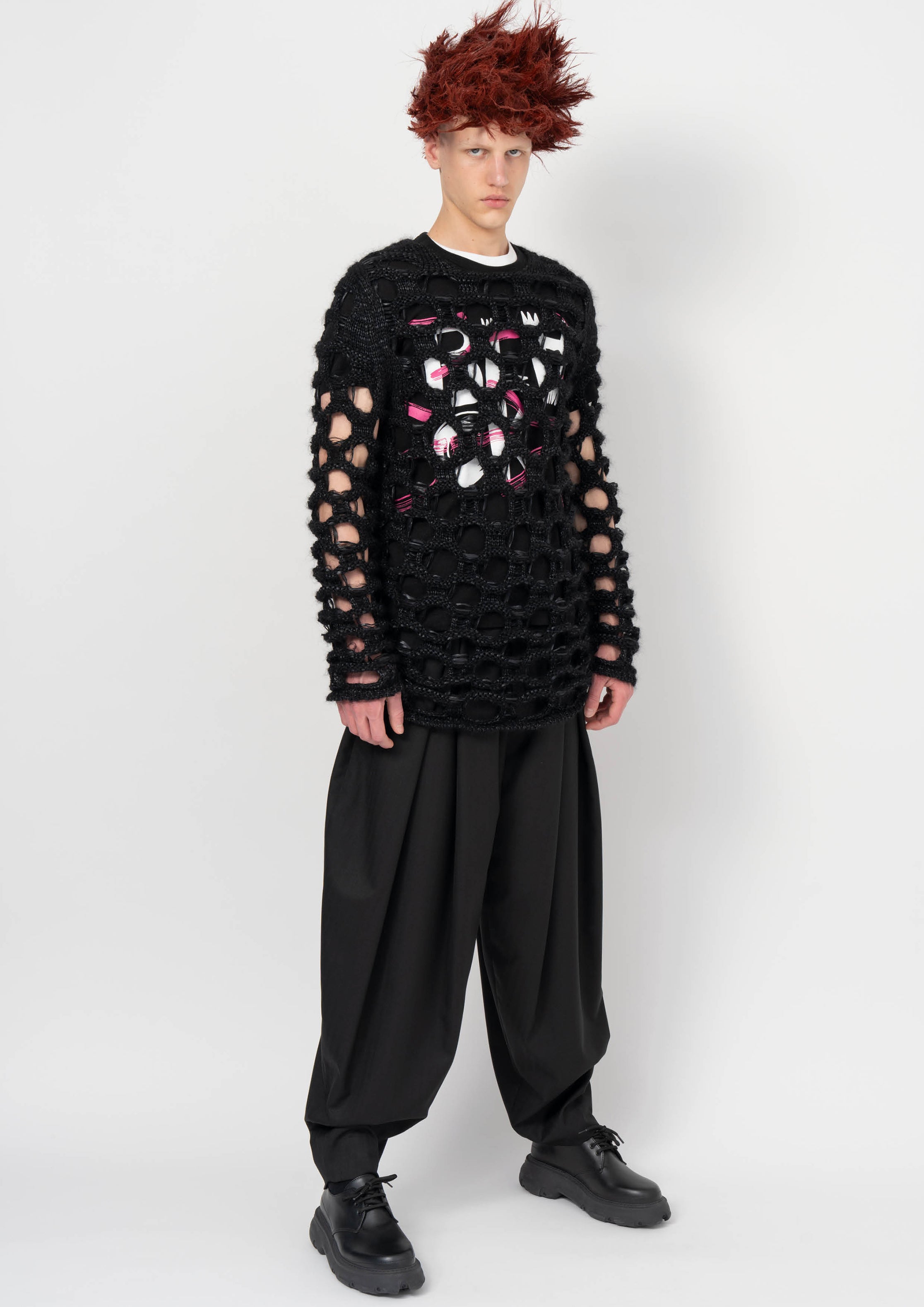 Fashion model wearing a BLACK COMME DES GARÇONS AW26 outfit