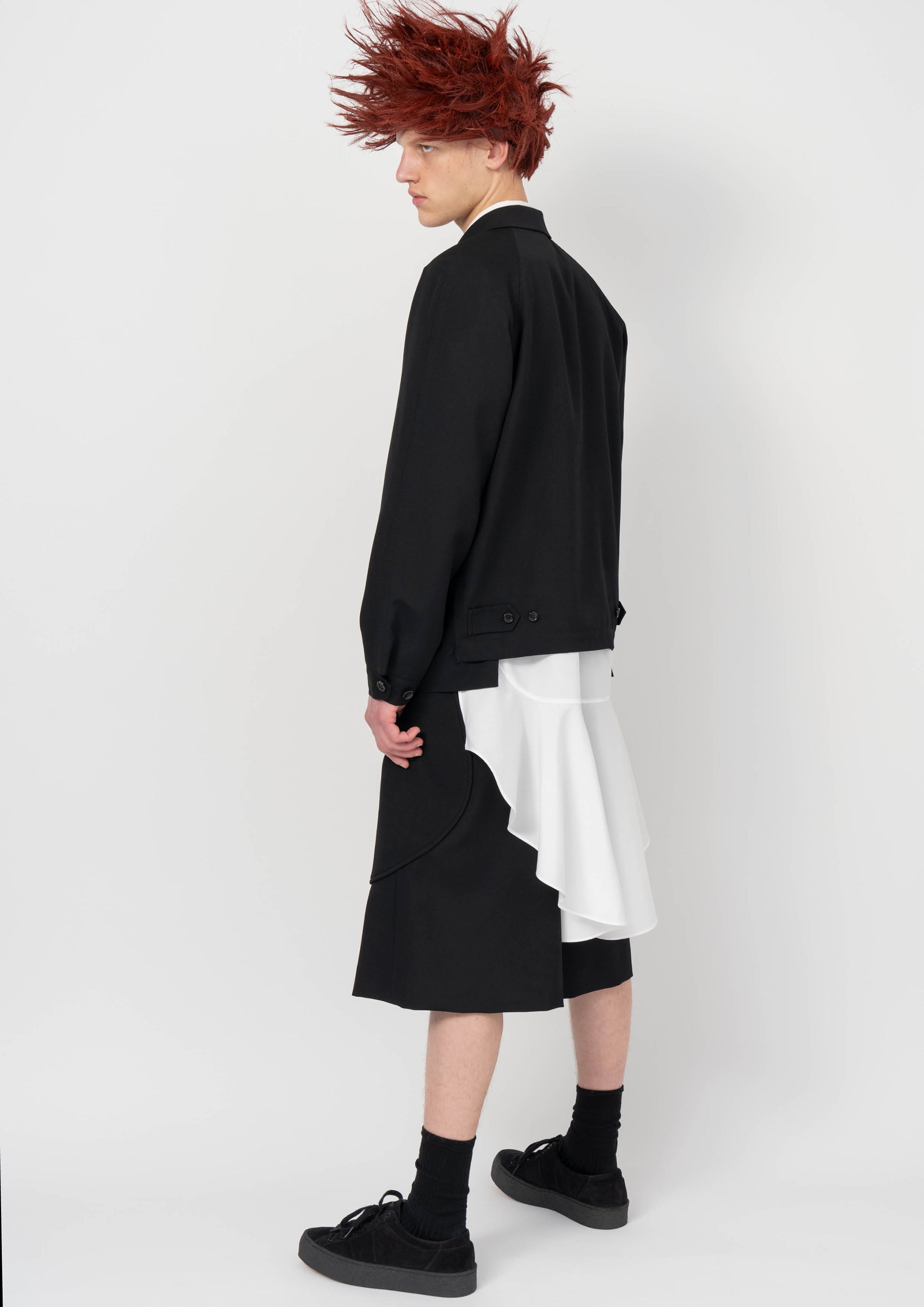 Fashion model wearing a BLACK COMME DES GARÇONS AW26 outfit