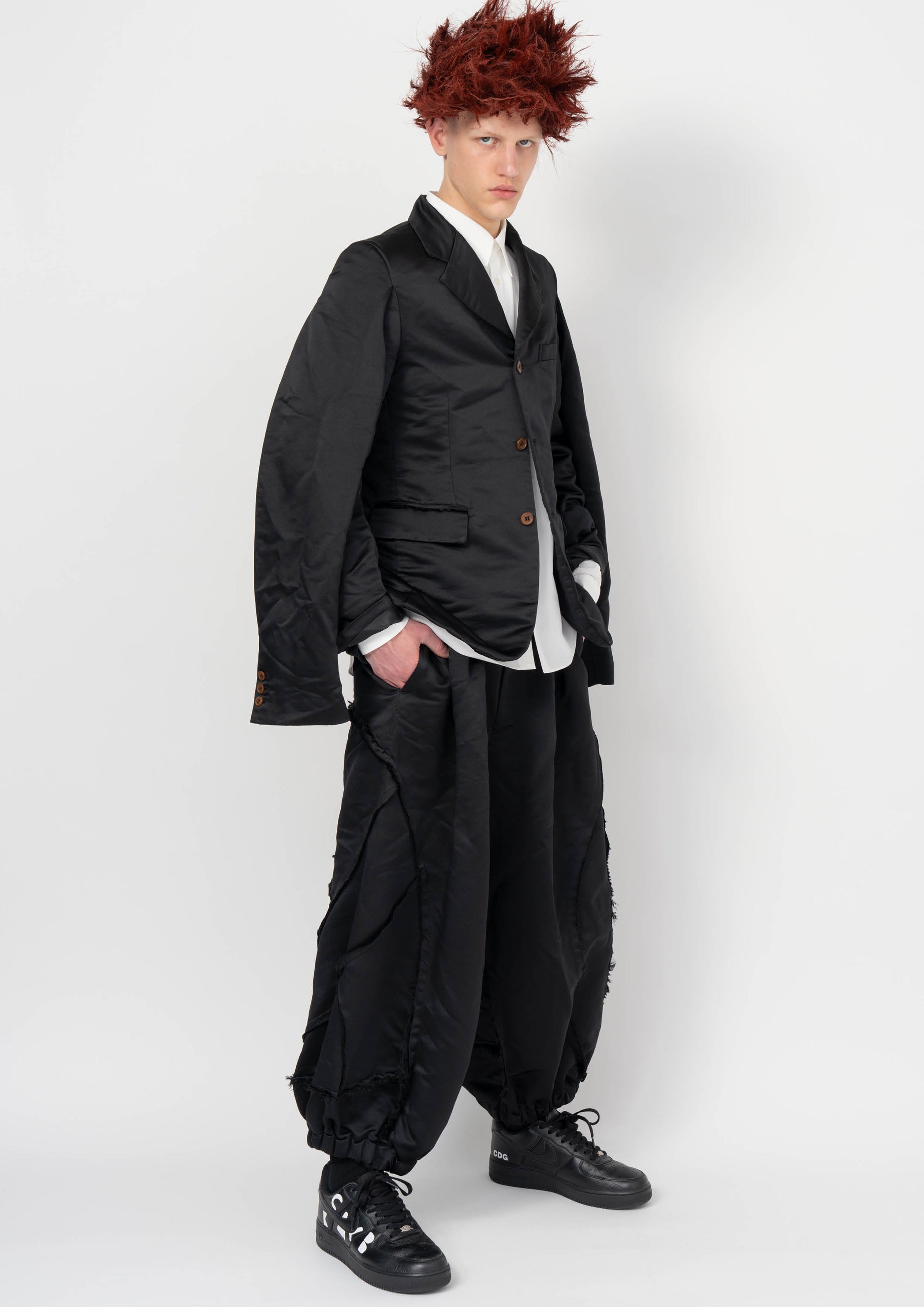 Fashion model wearing a BLACK COMME DES GARÇONS AW26 outfit