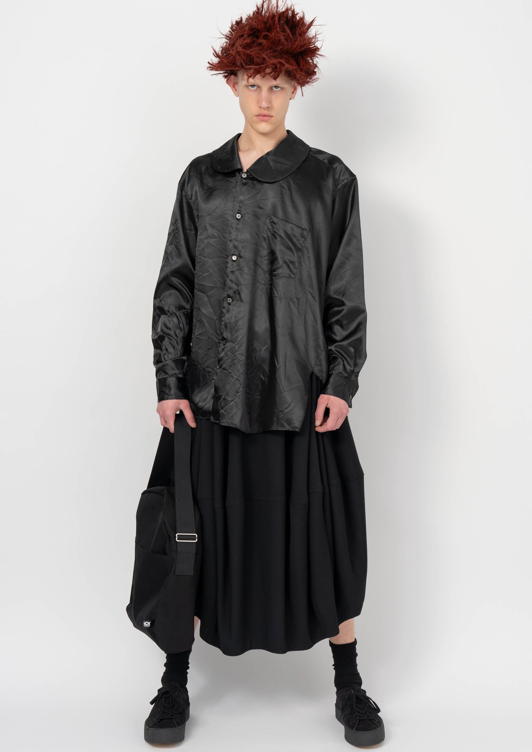 Fashion model wearing a BLACK COMME DES GARÇONS AW26 outfit