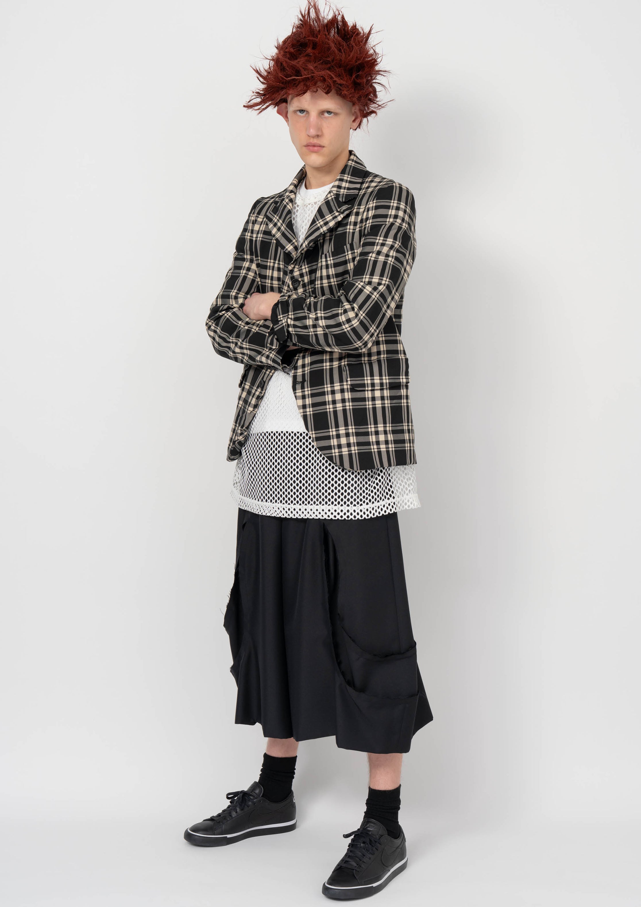 Fashion model wearing a BLACK COMME DES GARÇONS AW26 outfit