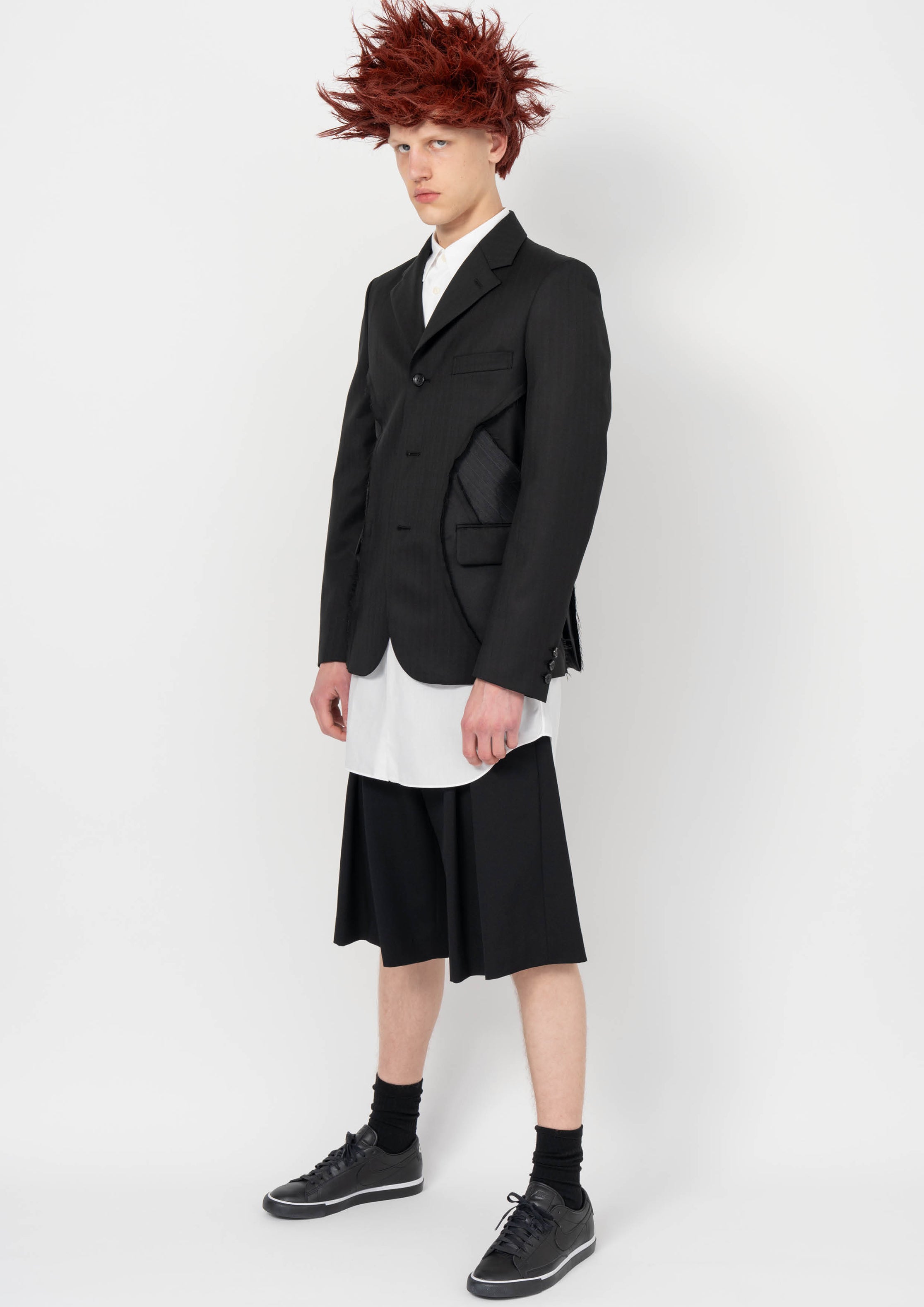 Fashion model wearing a BLACK COMME DES GARÇONS AW26 outfit