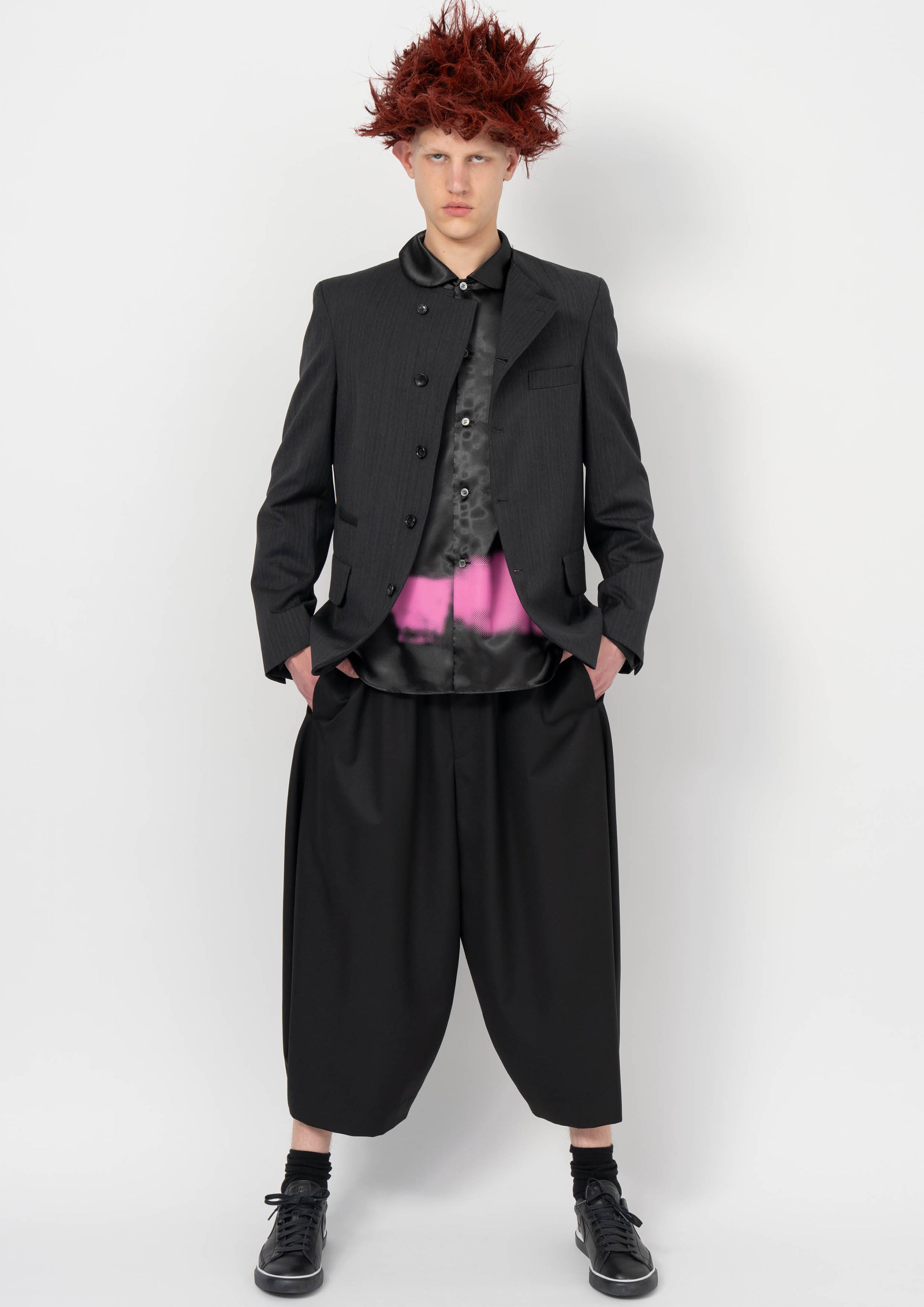 Fashion model wearing a BLACK COMME DES GARÇONS AW26 outfit