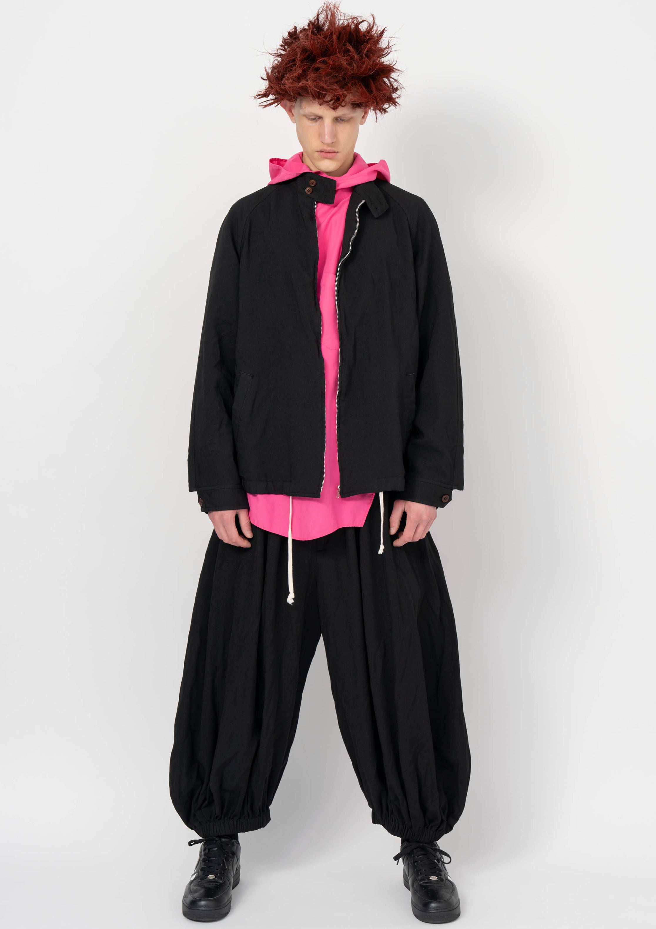 Fashion model wearing a BLACK COMME DES GARÇONS AW26 outfit