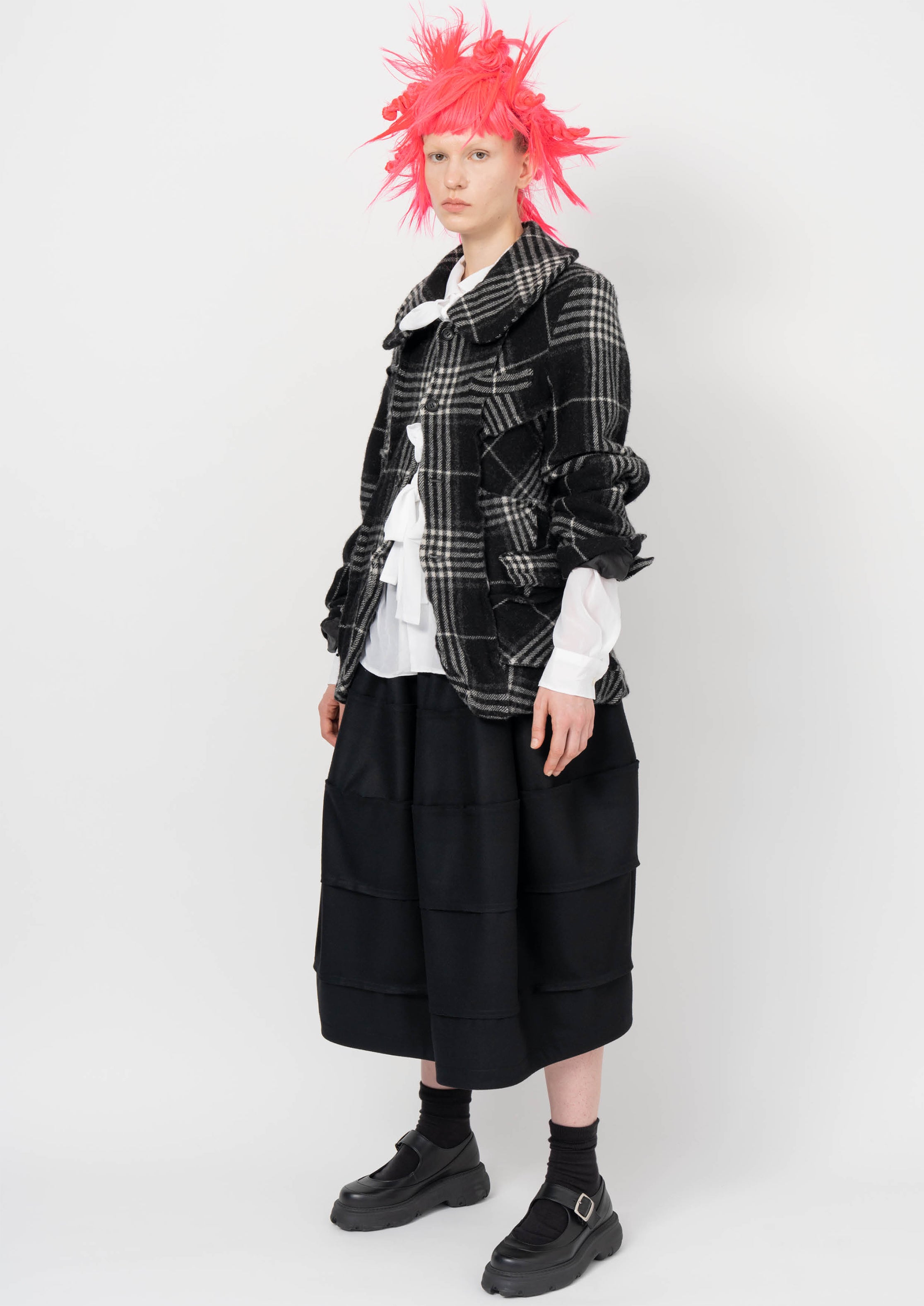 Fashion model wearing a BLACK COMME DES GARÇONS AW26 outfit