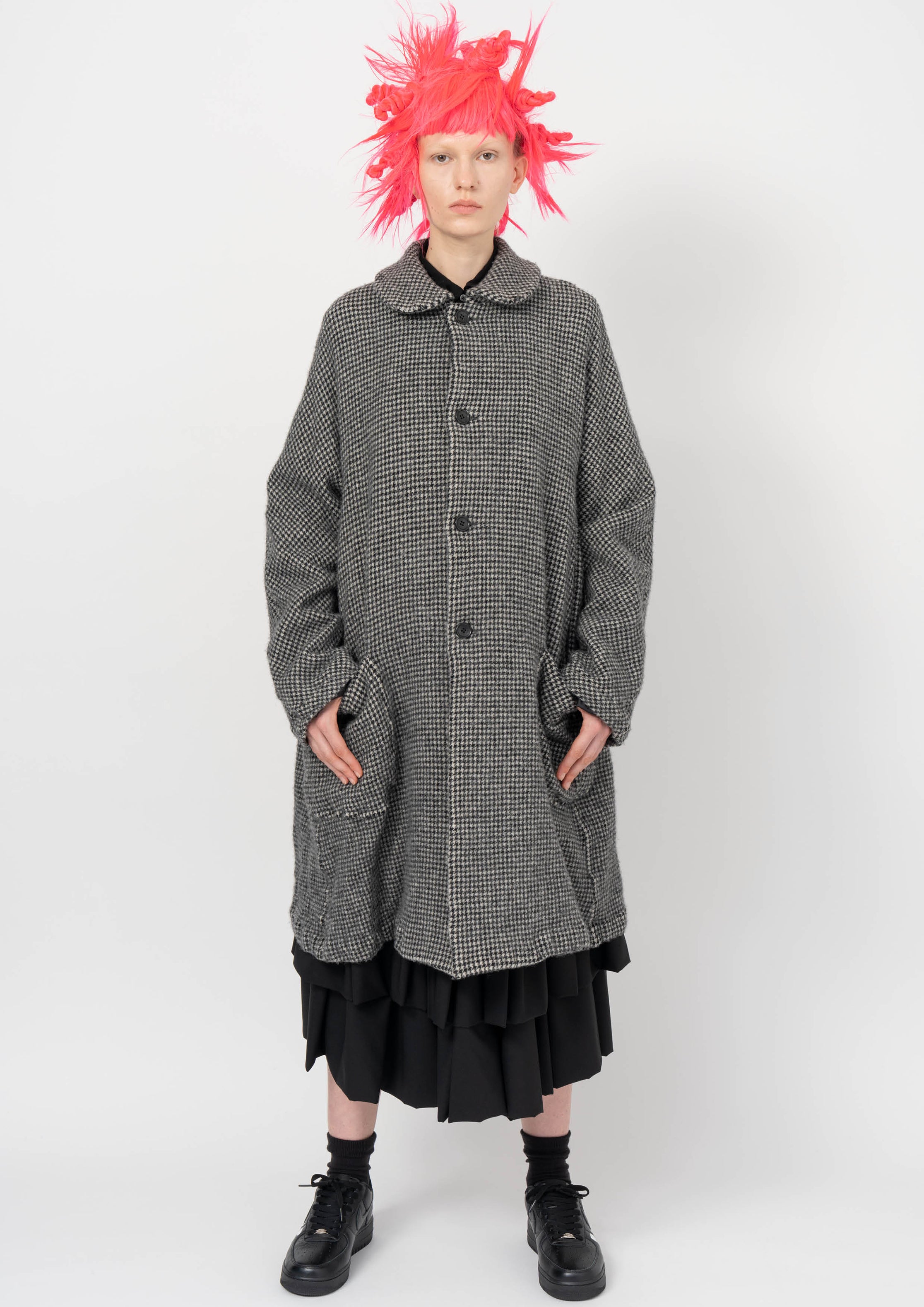 Fashion model wearing a BLACK COMME DES GARÇONS AW26 outfit