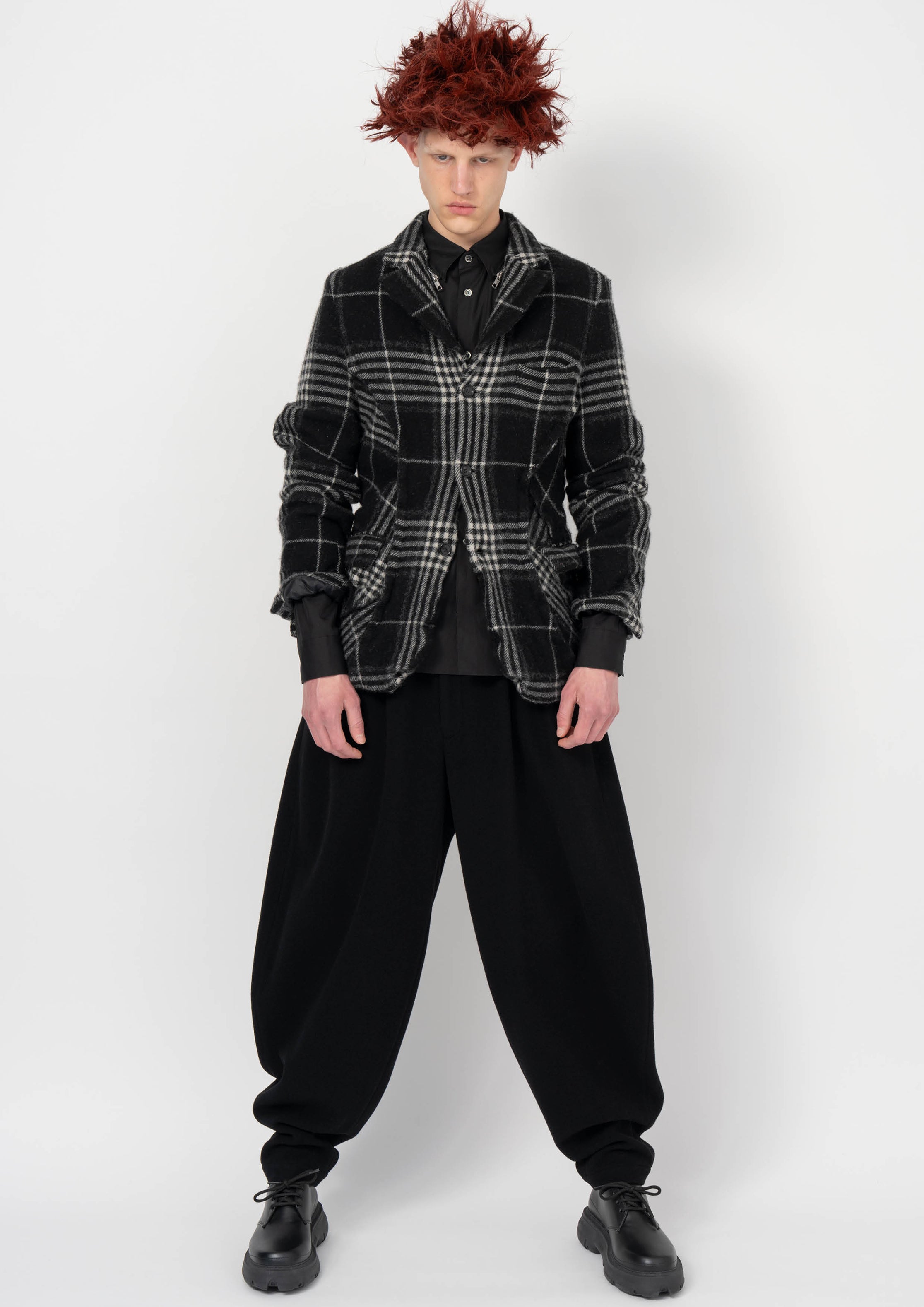 Fashion model wearing a BLACK COMME DES GARÇONS AW26 outfit