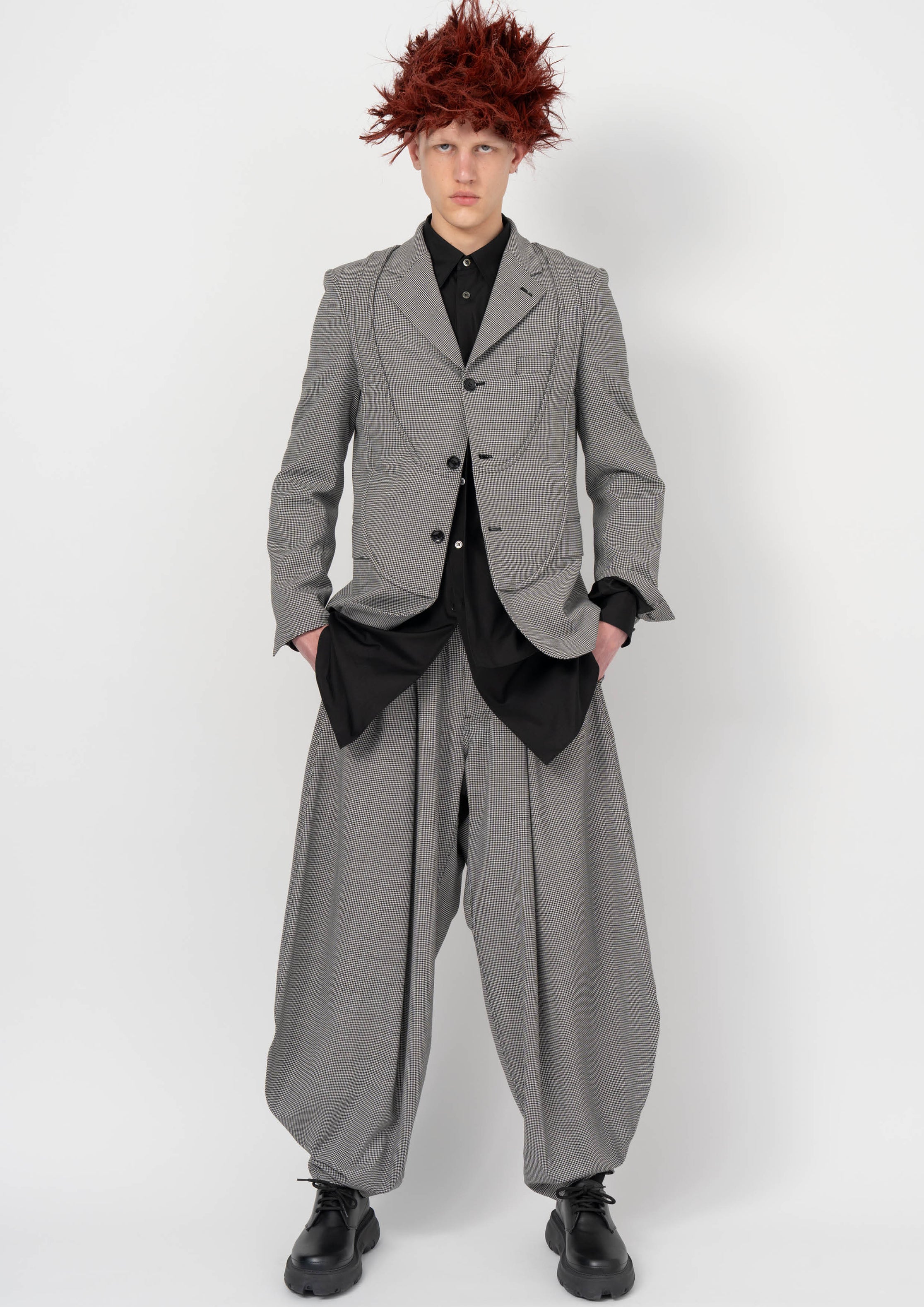 Fashion model wearing a BLACK COMME DES GARÇONS AW26 outfit