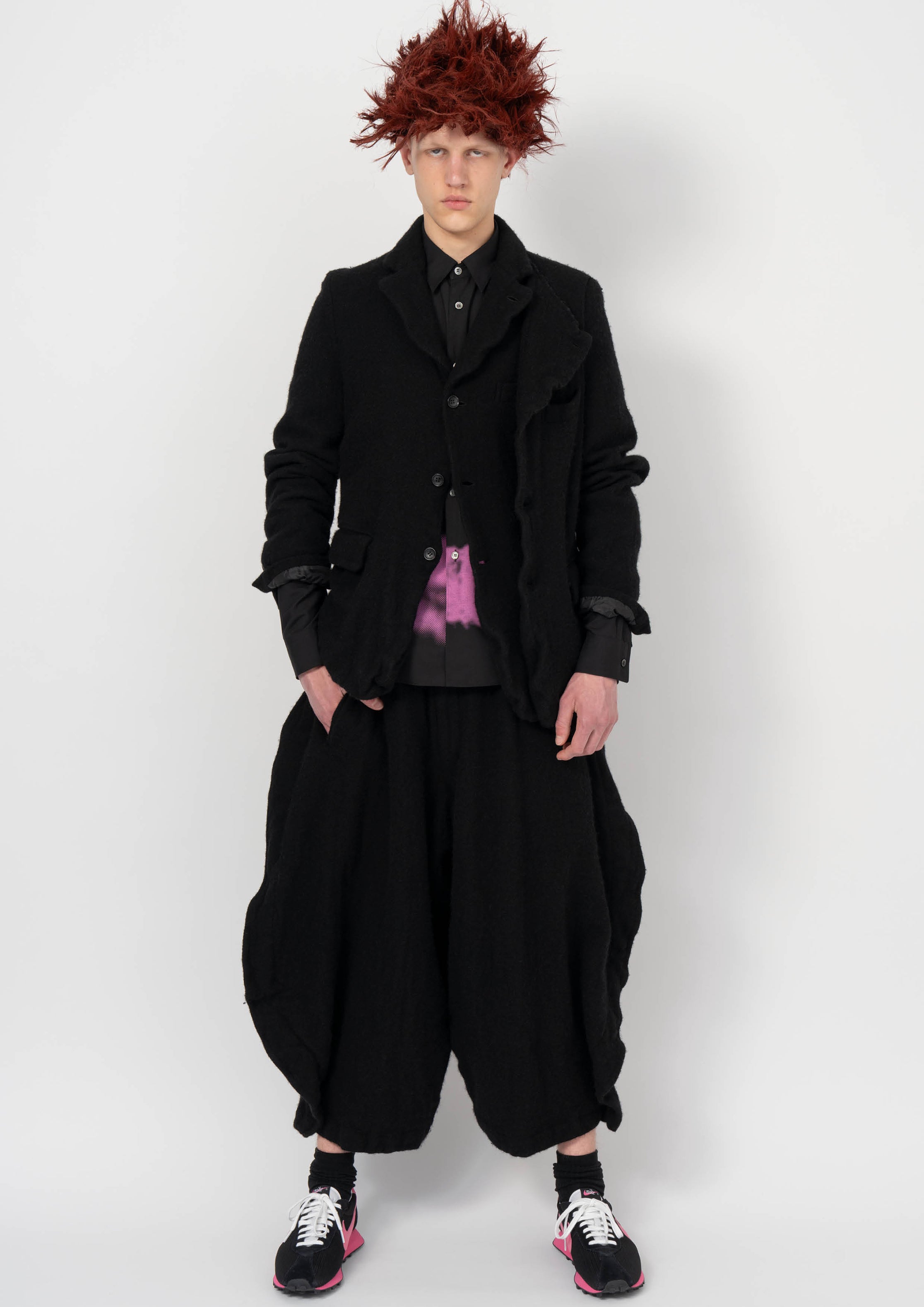 Fashion model wearing a BLACK COMME DES GARÇONS AW26 outfit