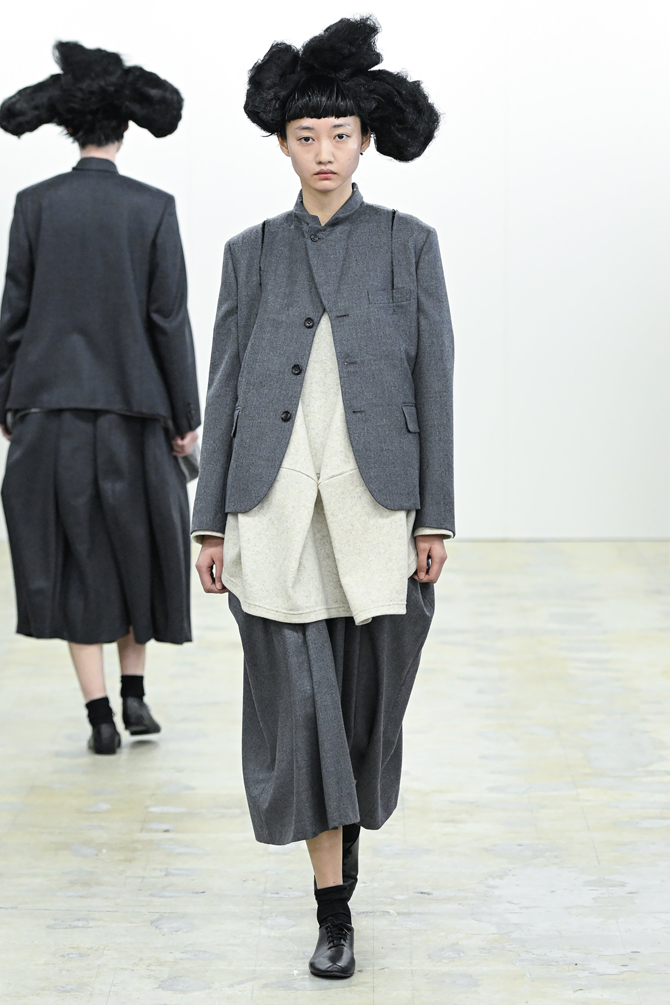 Fashion model wearing a COMME DES GARÇONS COMME DES GARÇONS AW26 outfit