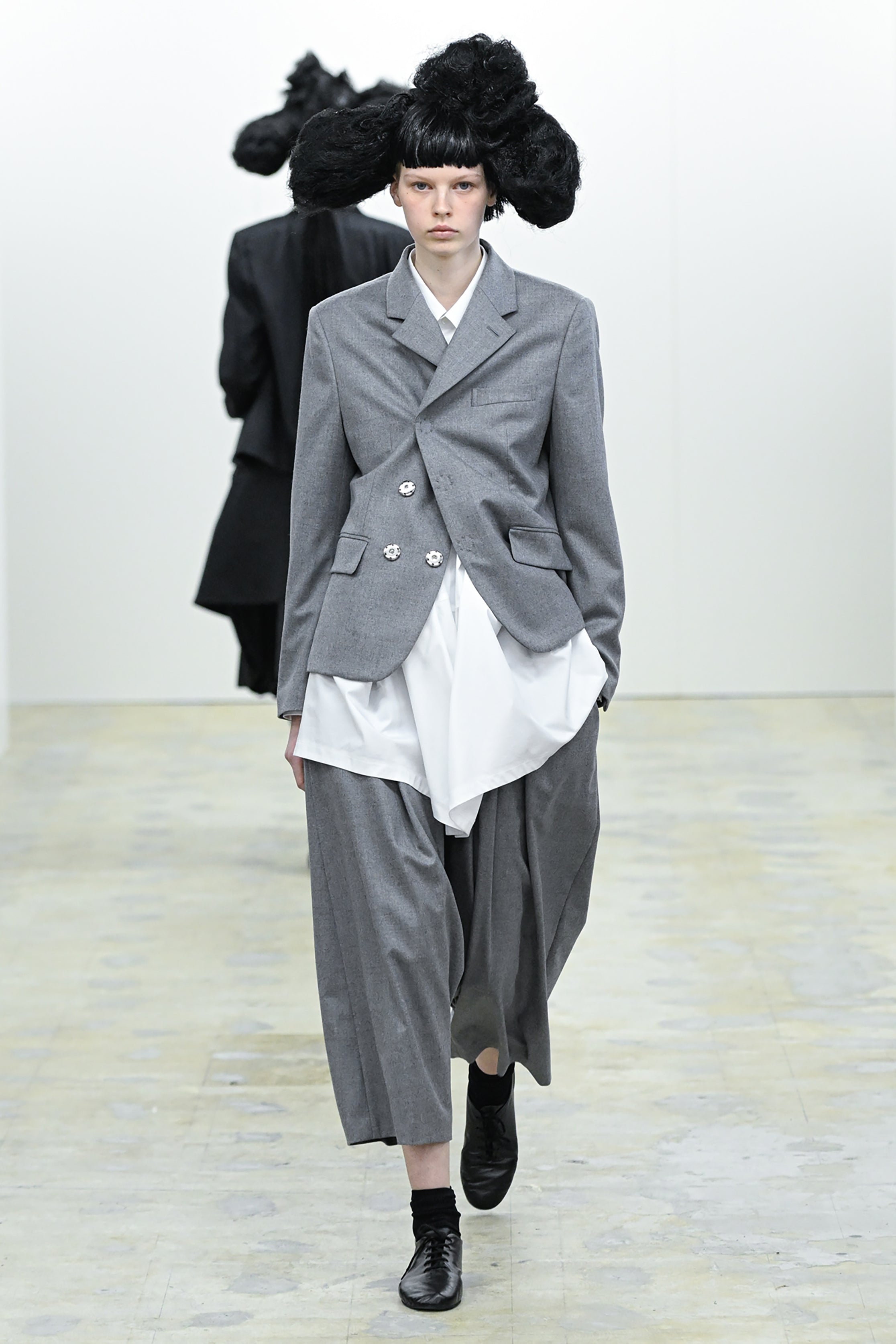 Fashion model wearing a COMME DES GARÇONS COMME DES GARÇONS AW26 outfit