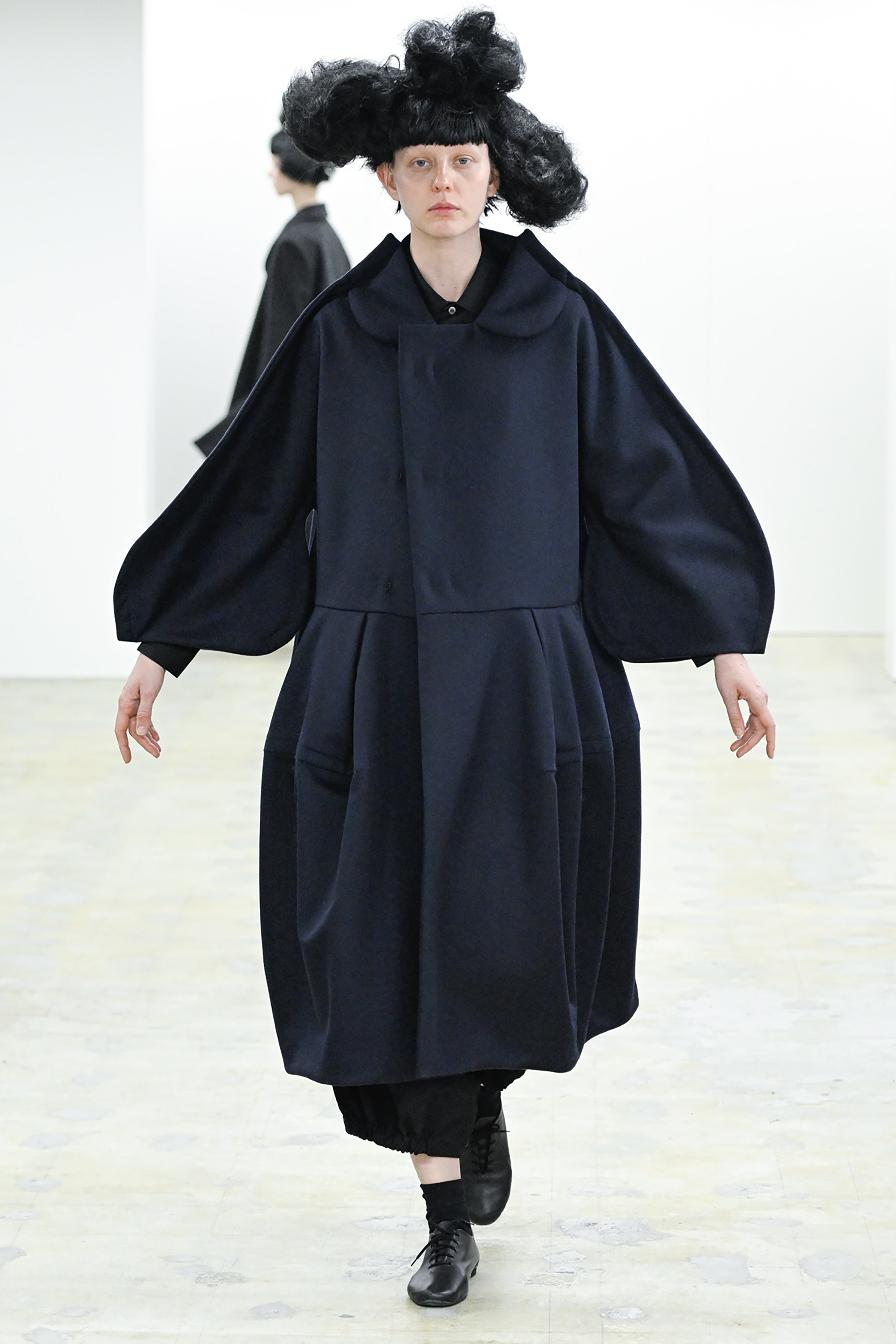 Fashion model wearing a COMME DES GARÇONS COMME DES GARÇONS AW26 outfit