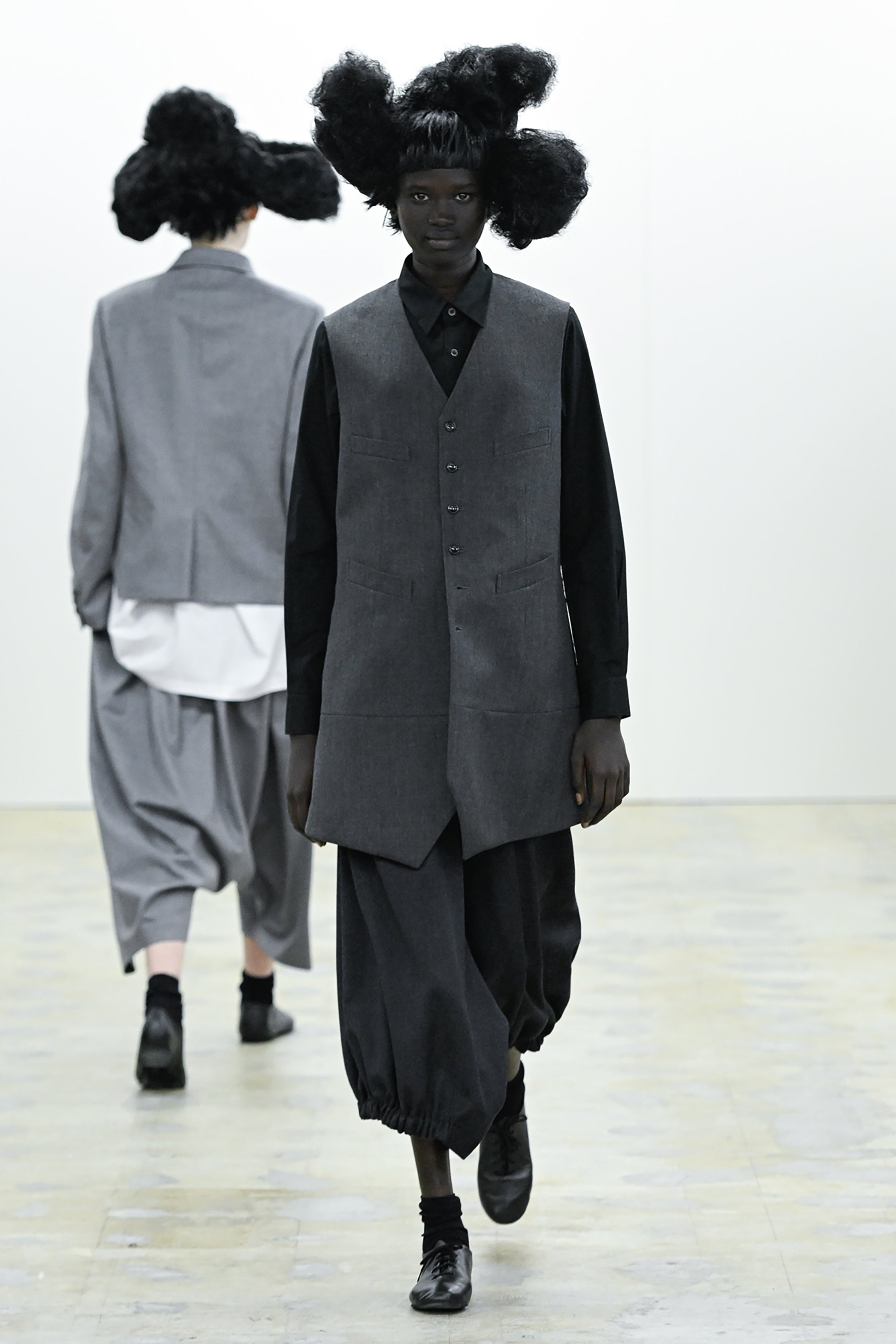 Fashion model wearing a COMME DES GARÇONS COMME DES GARÇONS AW26 outfit