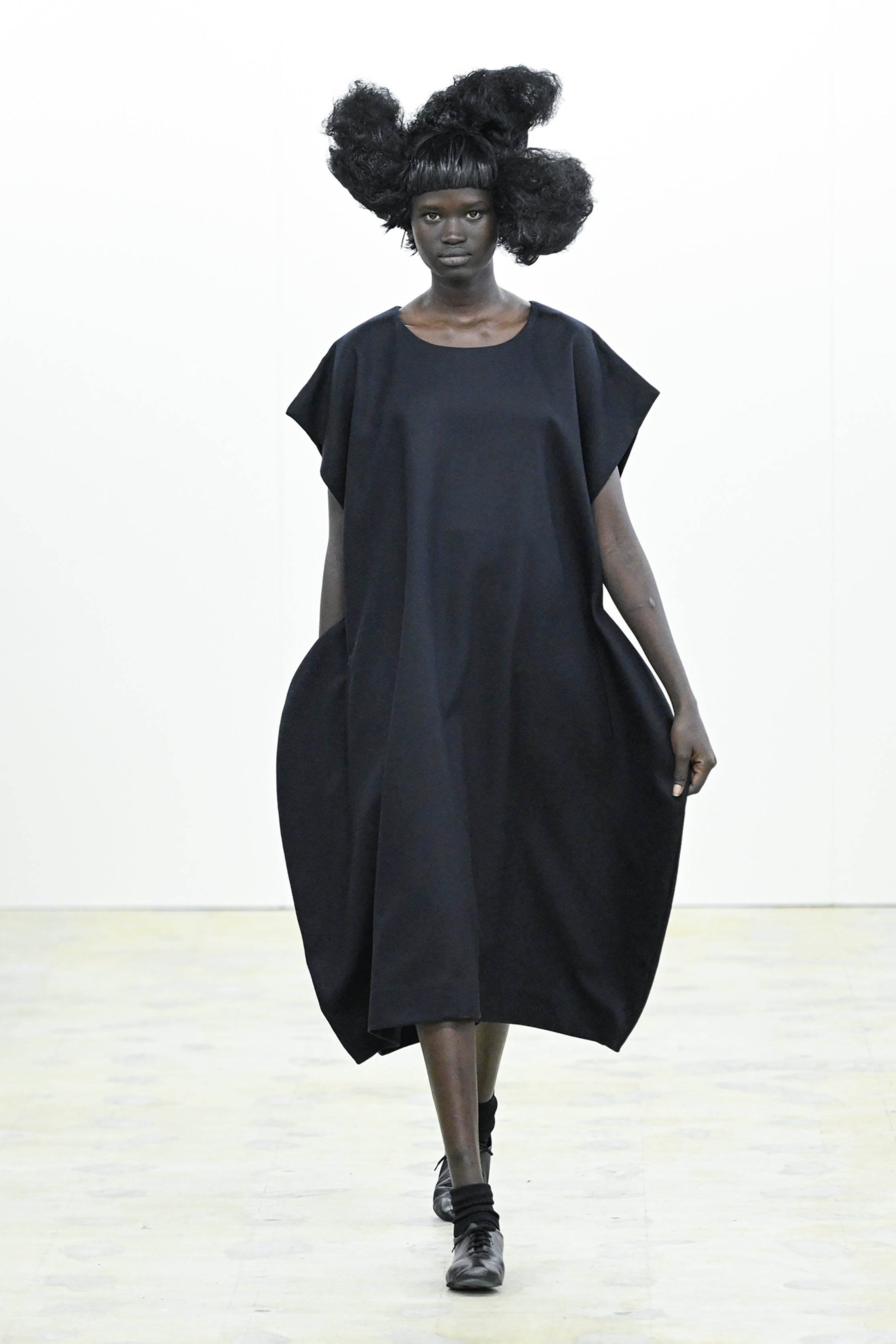 Fashion model wearing a COMME DES GARÇONS COMME DES GARÇONS AW26 outfit