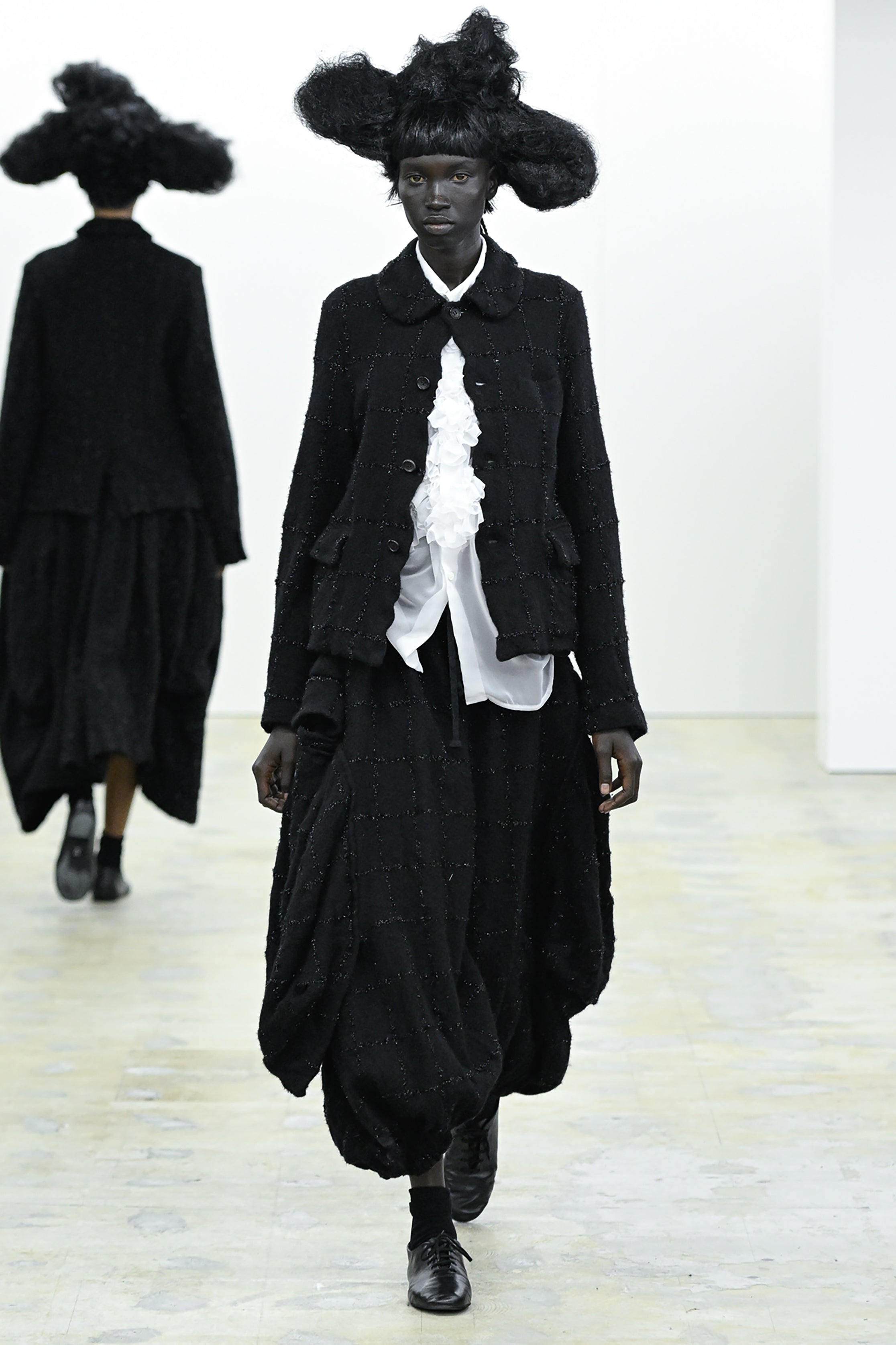 Fashion model wearing a COMME DES GARÇONS COMME DES GARÇONS AW26 outfit