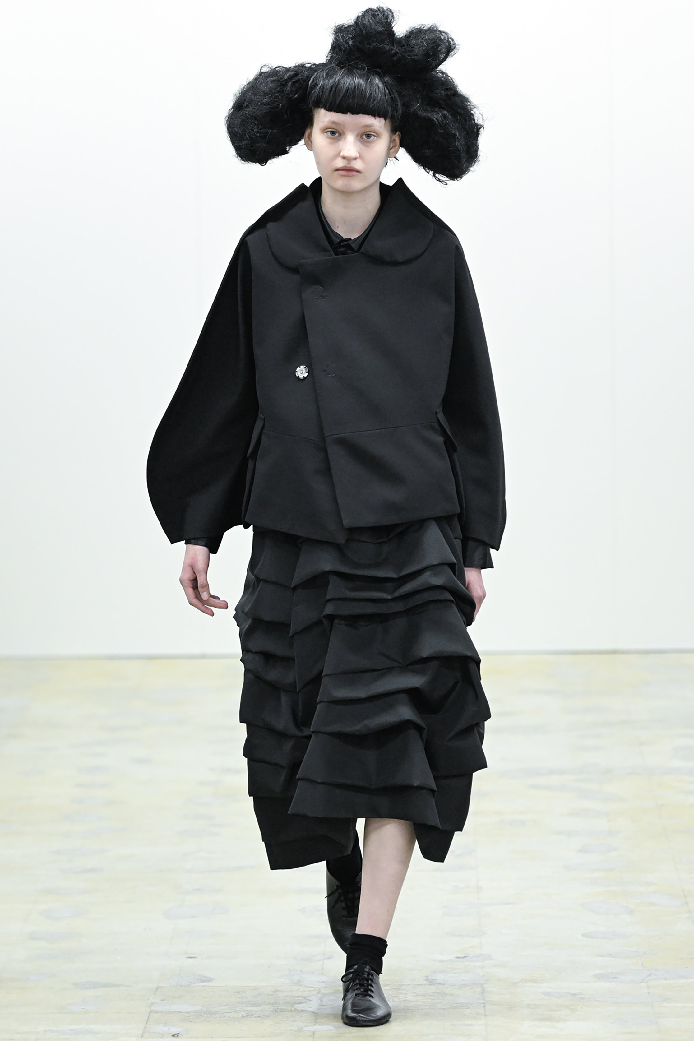 Fashion model wearing a COMME DES GARÇONS COMME DES GARÇONS AW26 outfit