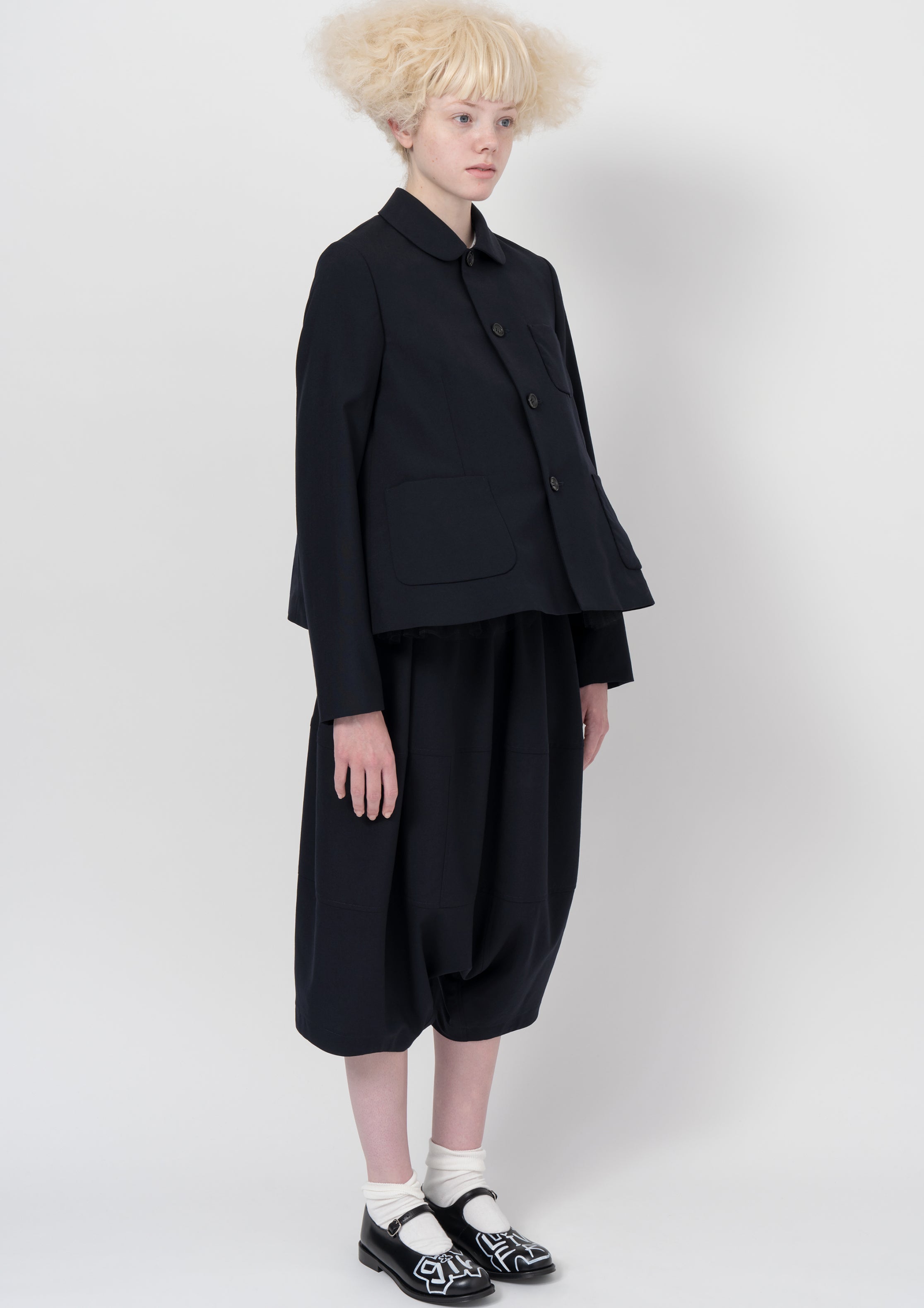 Fashion model wearing a COMME DES GARÇONS GIRL AW26 outfit