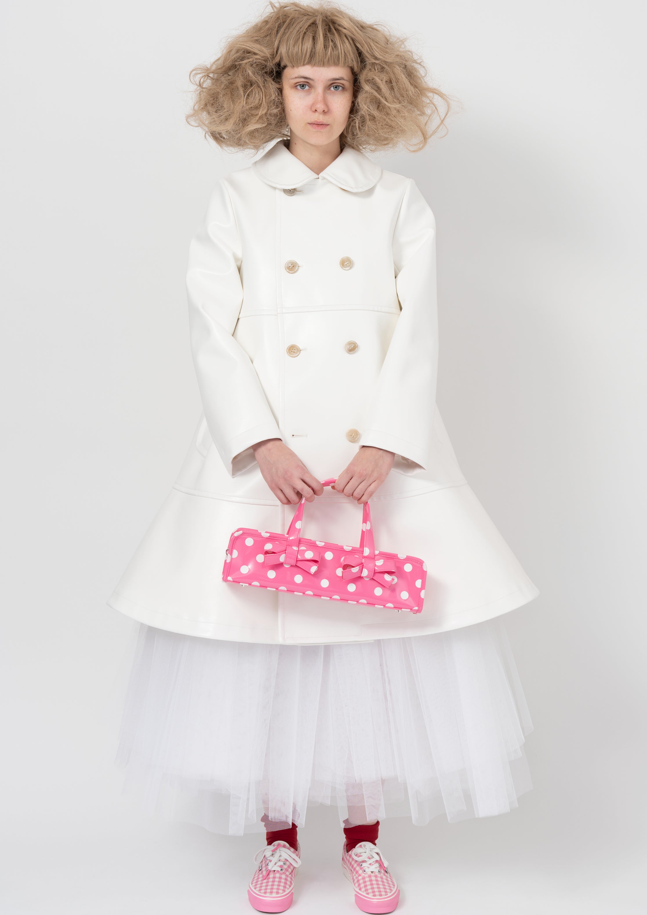 Fashion model wearing a COMME DES GARÇONS GIRL AW26 outfit