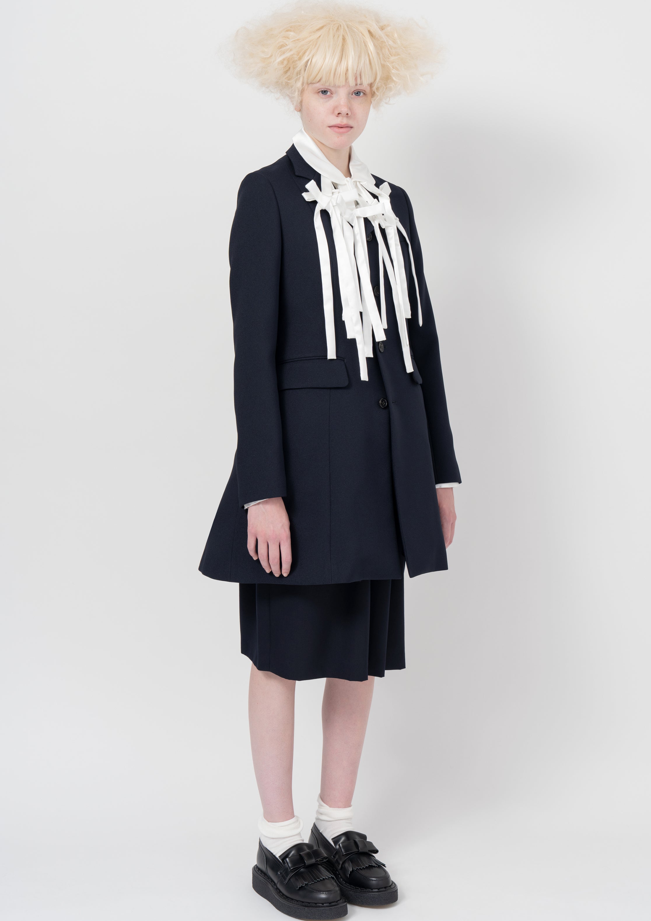Fashion model wearing a COMME DES GARÇONS GIRL AW26 outfit