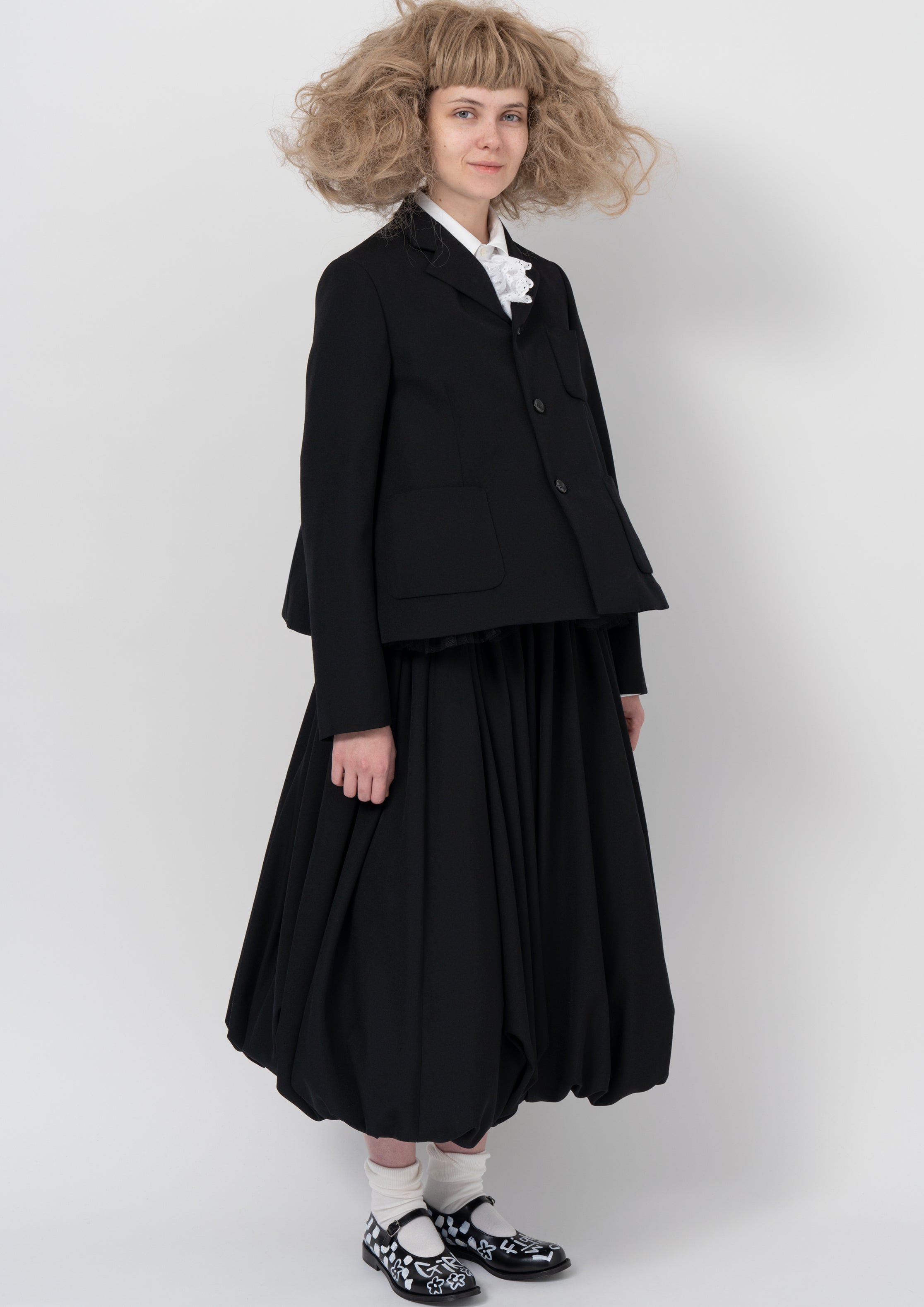 Fashion model wearing a COMME DES GARÇONS GIRL AW26 outfit