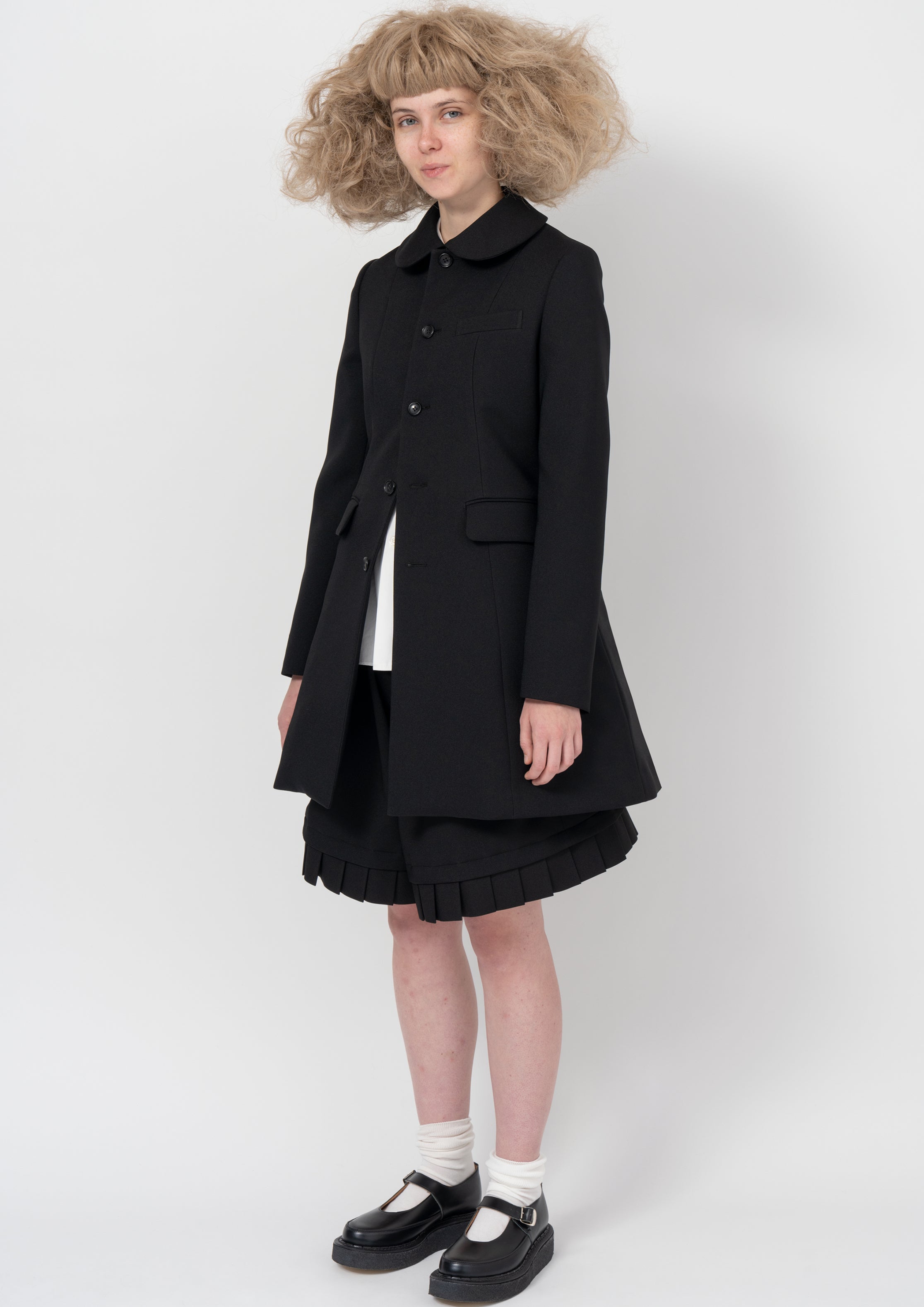 Fashion model wearing a COMME DES GARÇONS GIRL AW26 outfit