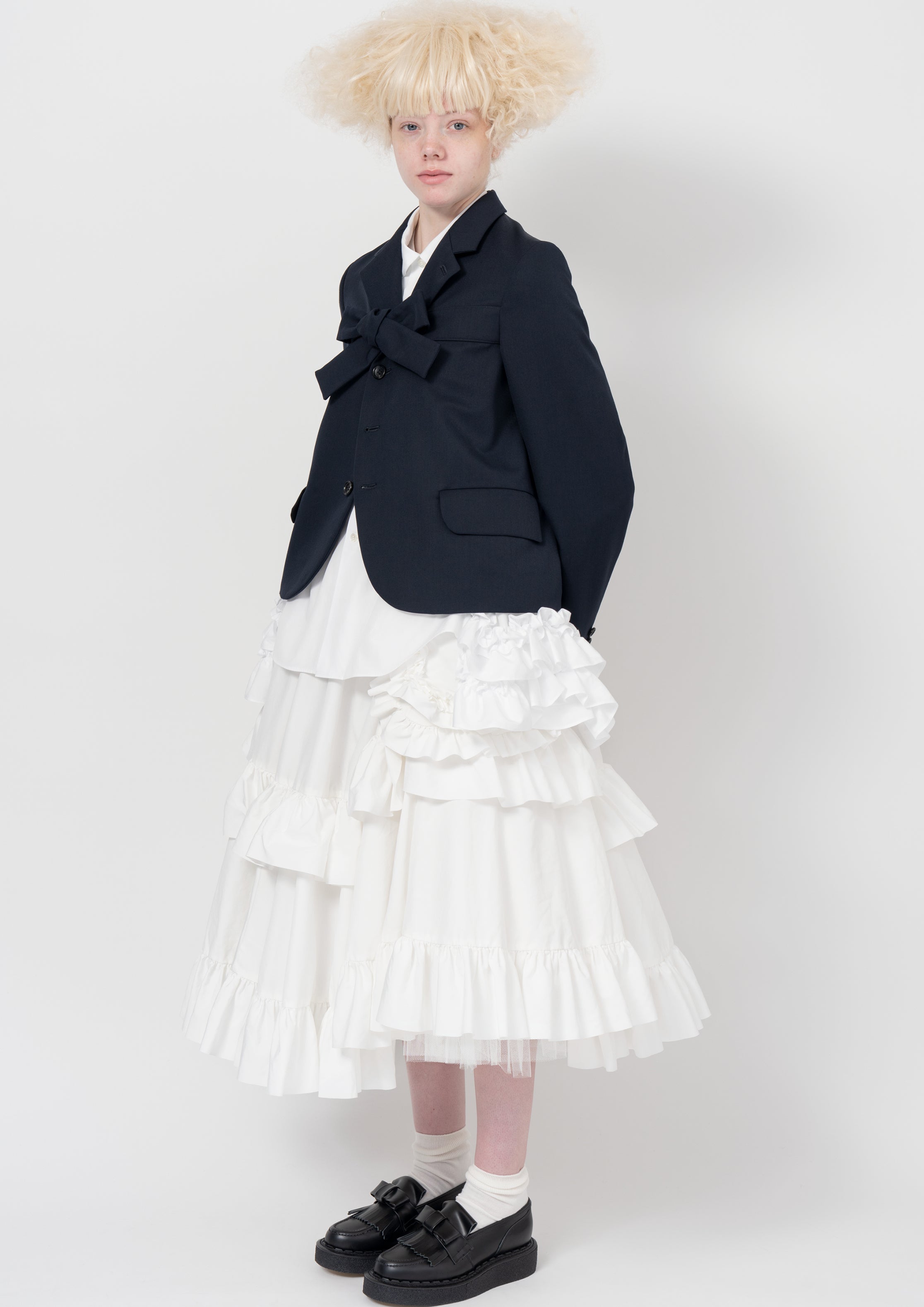 Fashion model wearing a COMME DES GARÇONS GIRL AW26 outfit