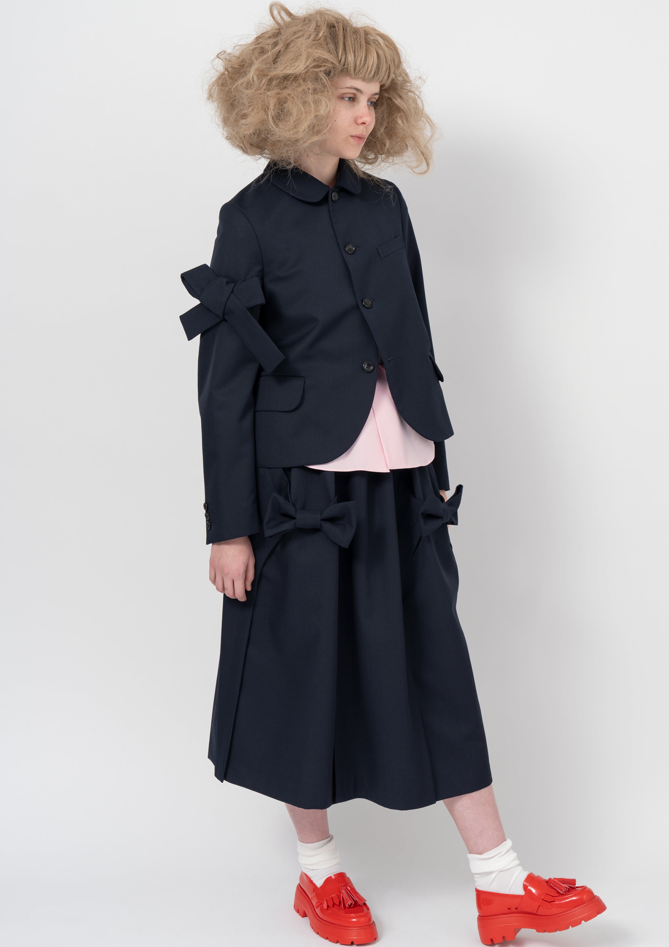 Fashion model wearing a COMME DES GARÇONS GIRL AW26 outfit