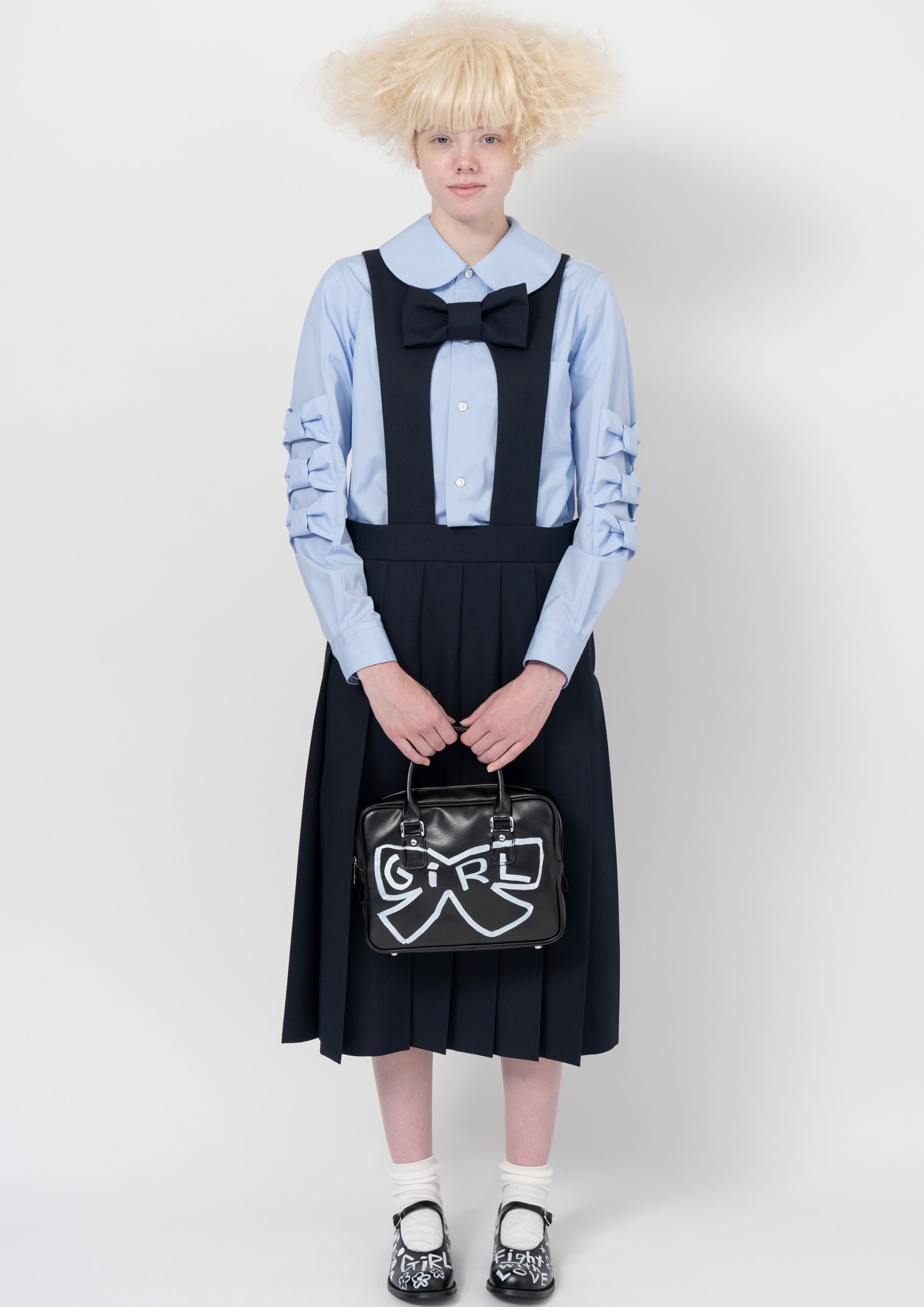 Fashion model wearing a COMME DES GARÇONS GIRL AW26 outfit