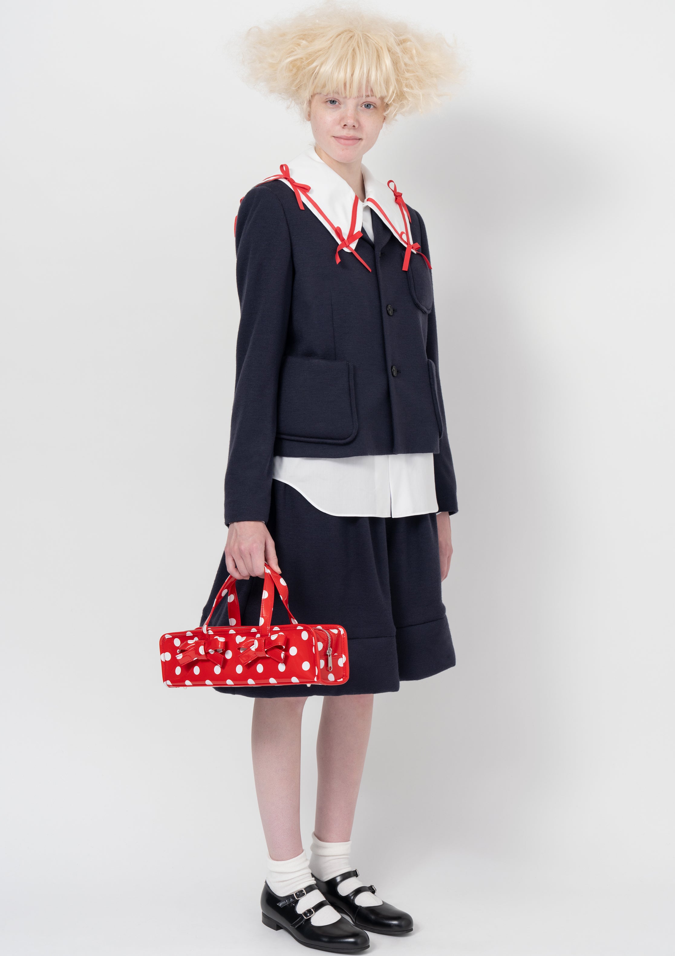 Fashion model wearing a COMME DES GARÇONS GIRL AW26 outfit