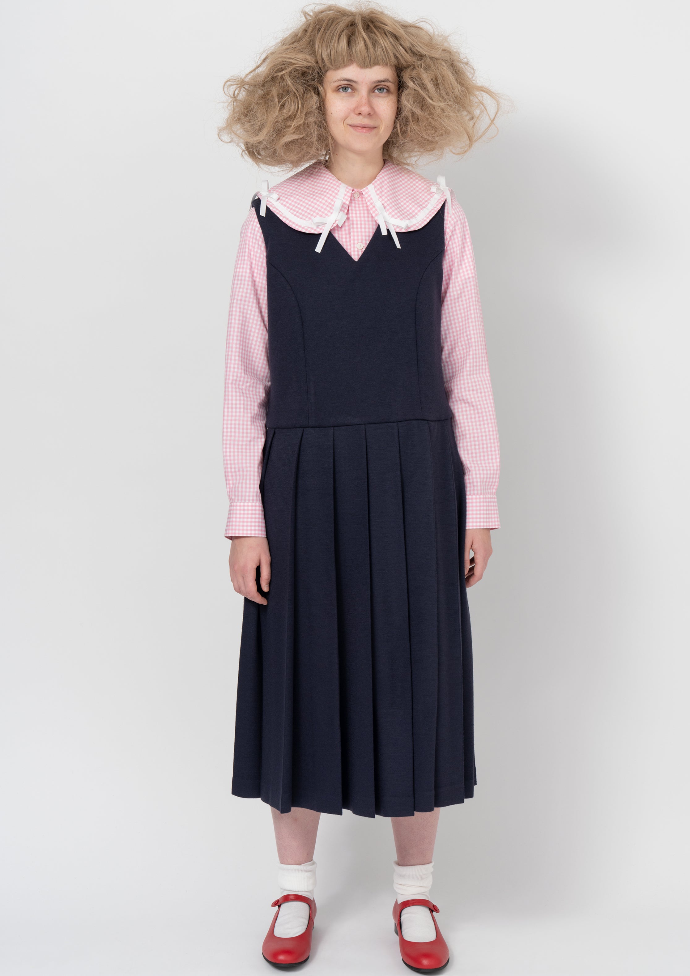 Fashion model wearing a COMME DES GARÇONS GIRL AW26 outfit