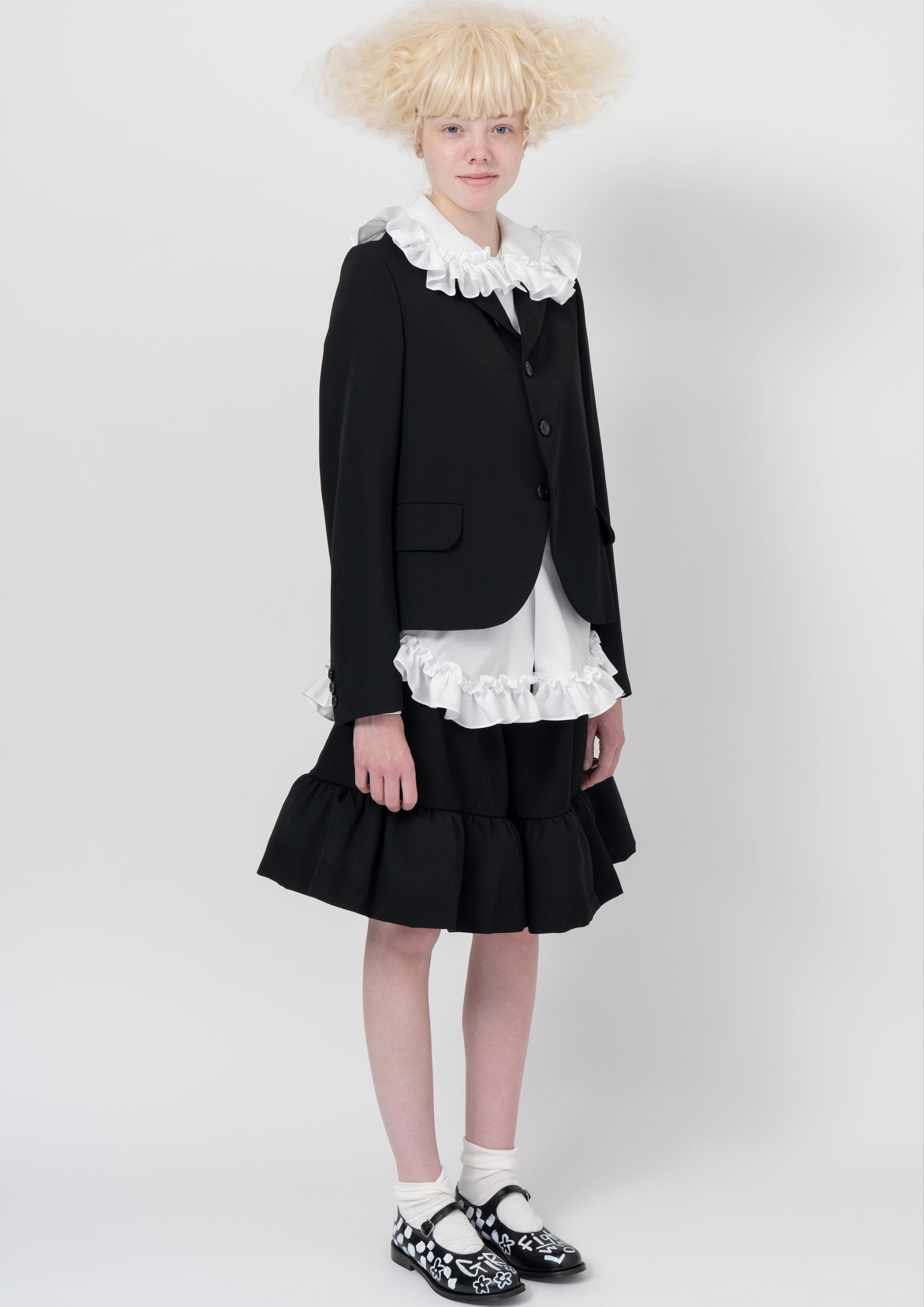 Fashion model wearing a COMME DES GARÇONS GIRL AW26 outfit