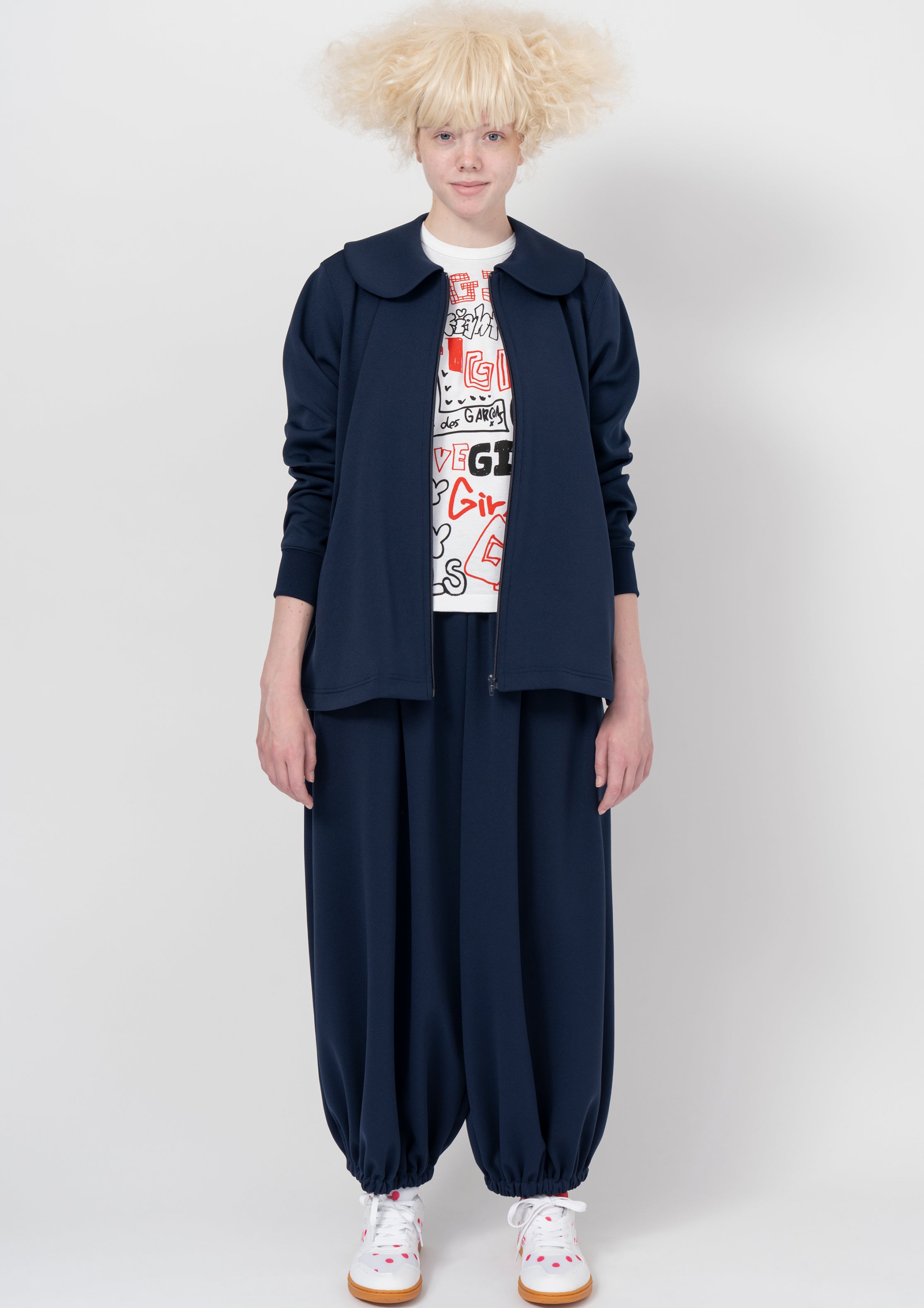 Fashion model wearing a COMME DES GARÇONS GIRL AW26 outfit