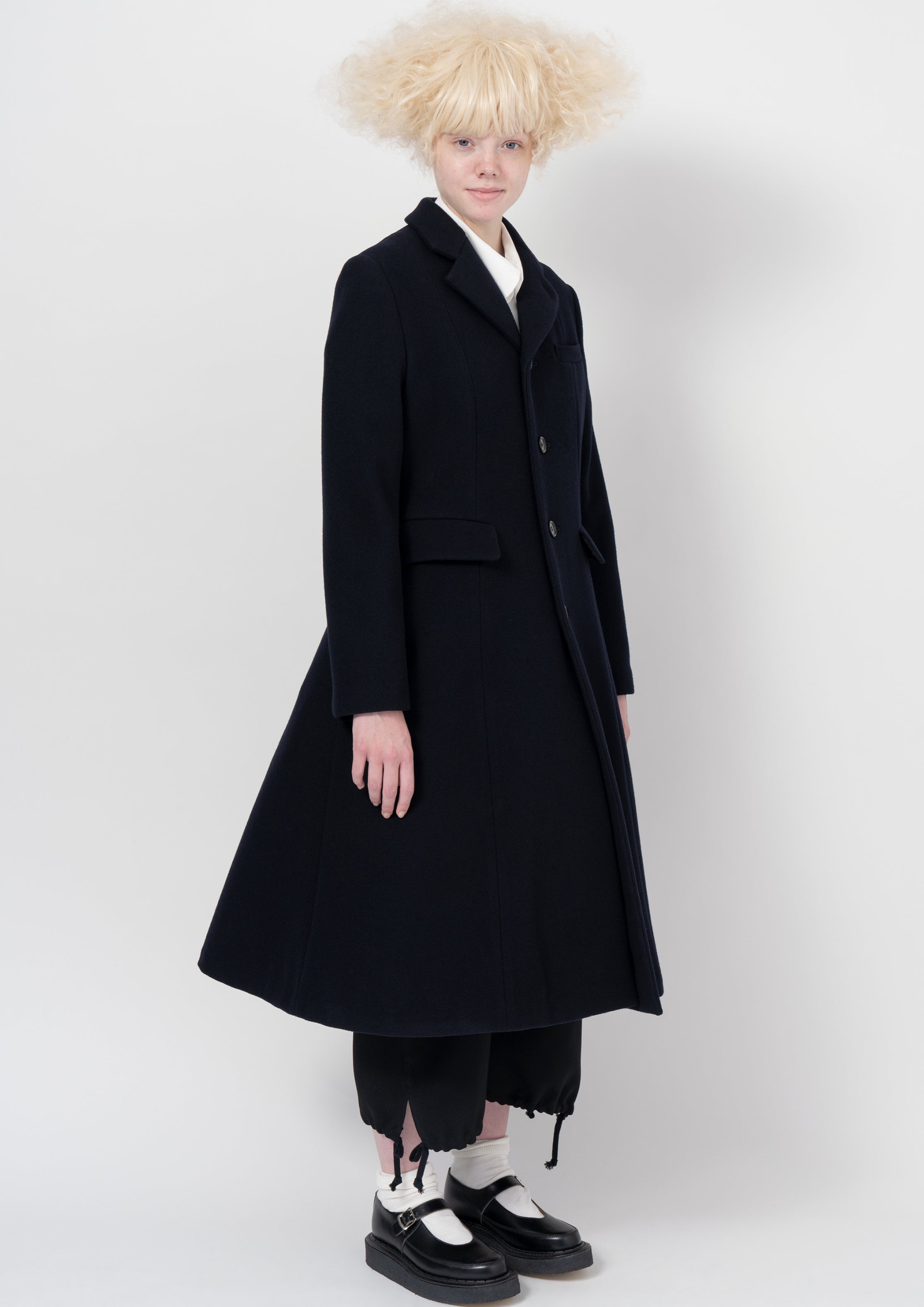 Fashion model wearing a COMME DES GARÇONS GIRL AW26 outfit