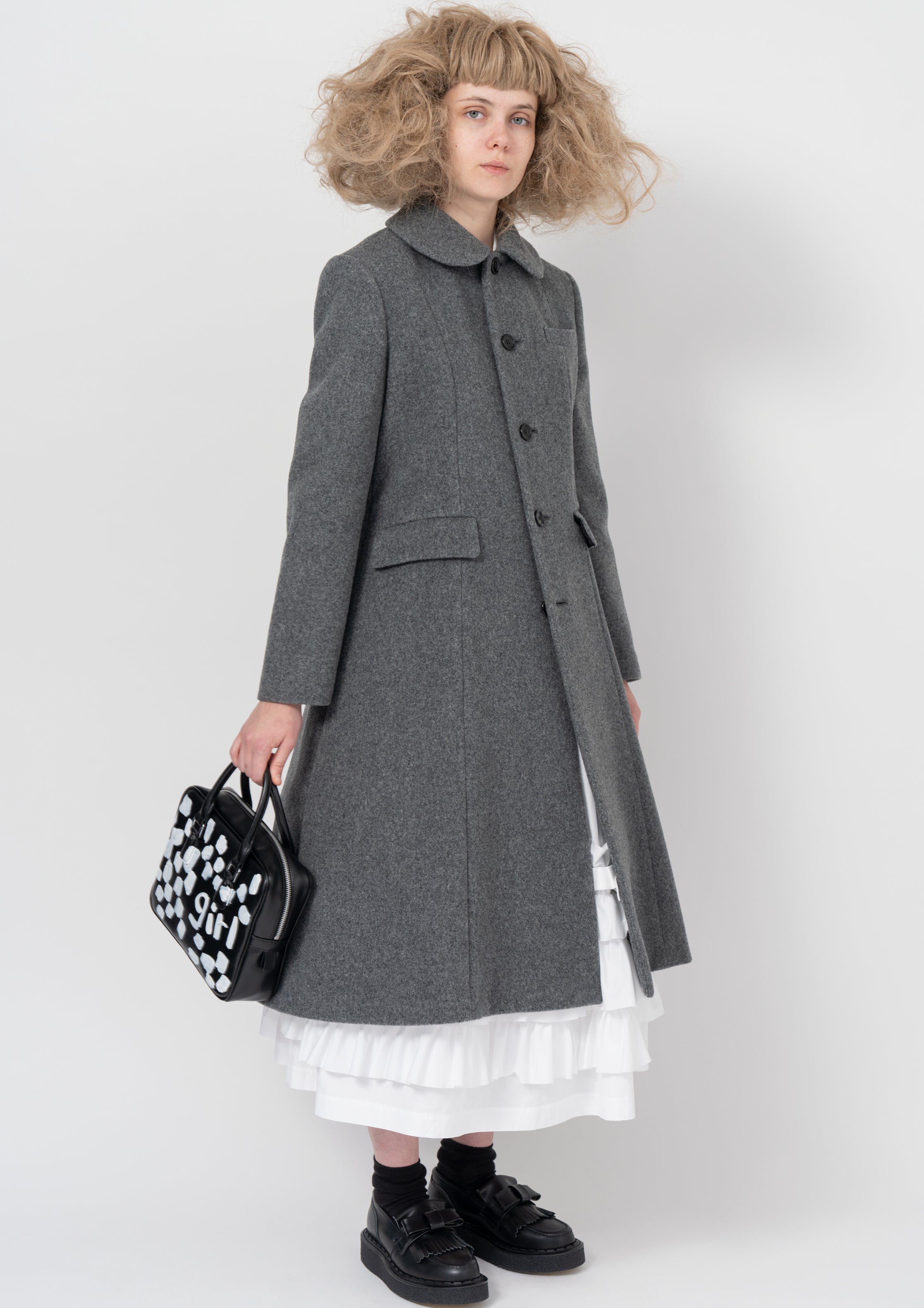 Fashion model wearing a COMME DES GARÇONS GIRL AW26 outfit