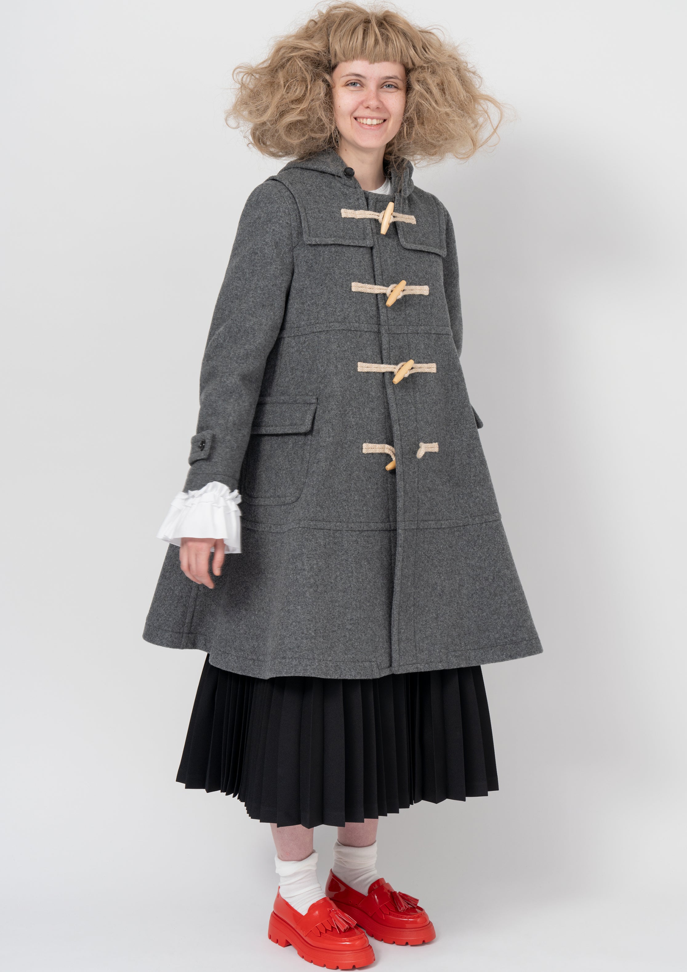 Fashion model wearing a COMME DES GARÇONS GIRL AW26 outfit
