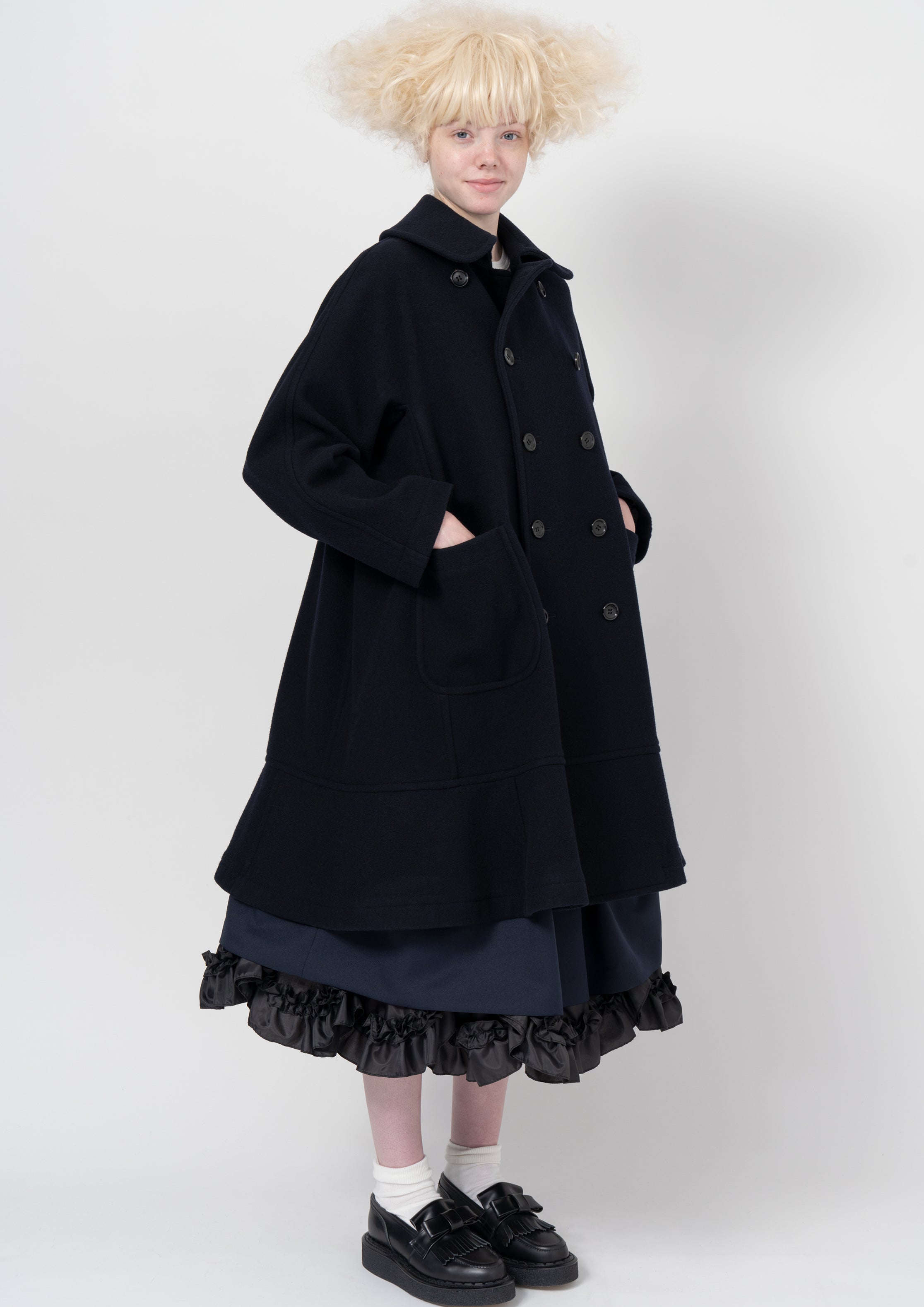 Fashion model wearing a COMME DES GARÇONS GIRL AW26 outfit
