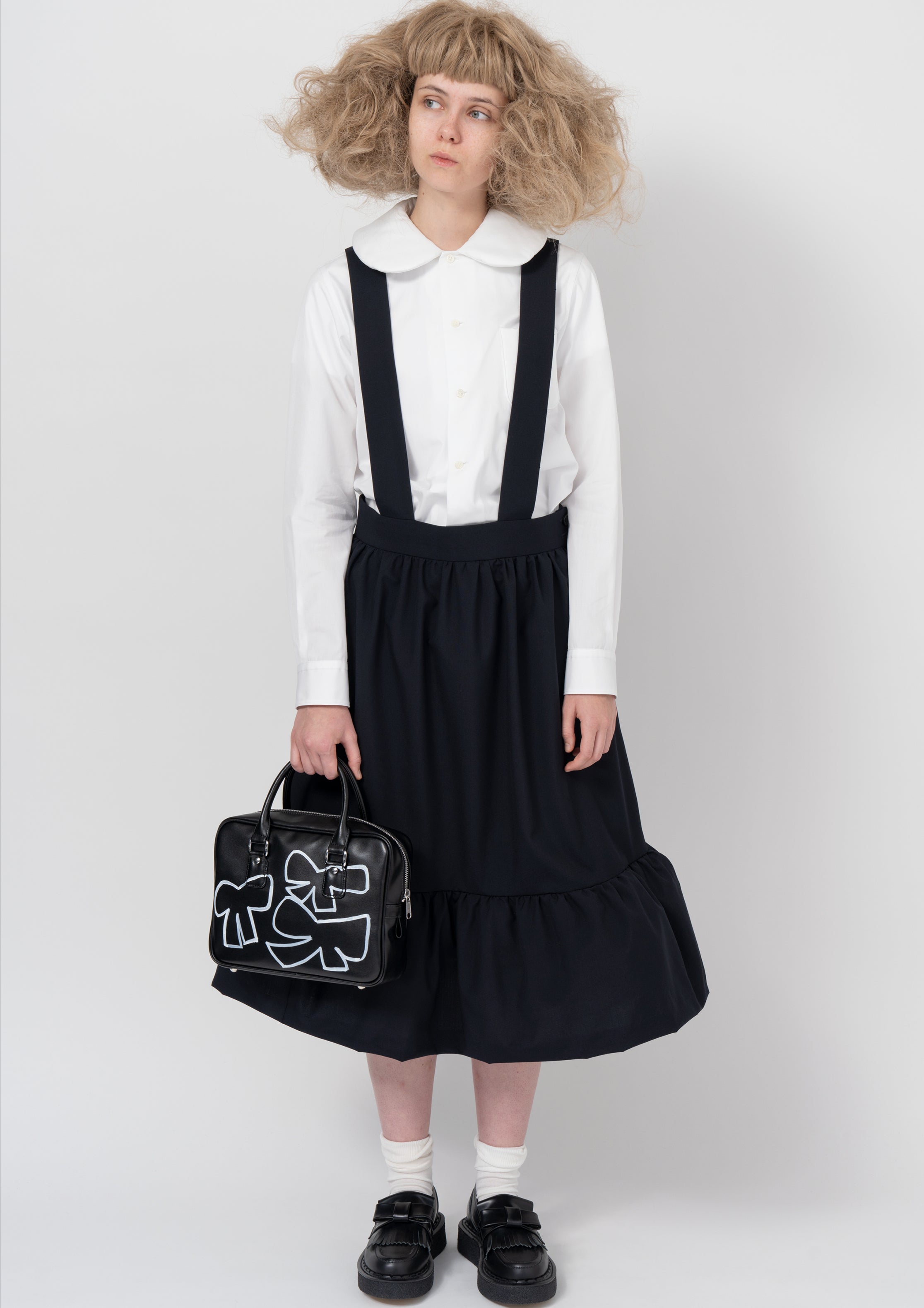 Fashion model wearing a COMME DES GARÇONS GIRL AW26 outfit