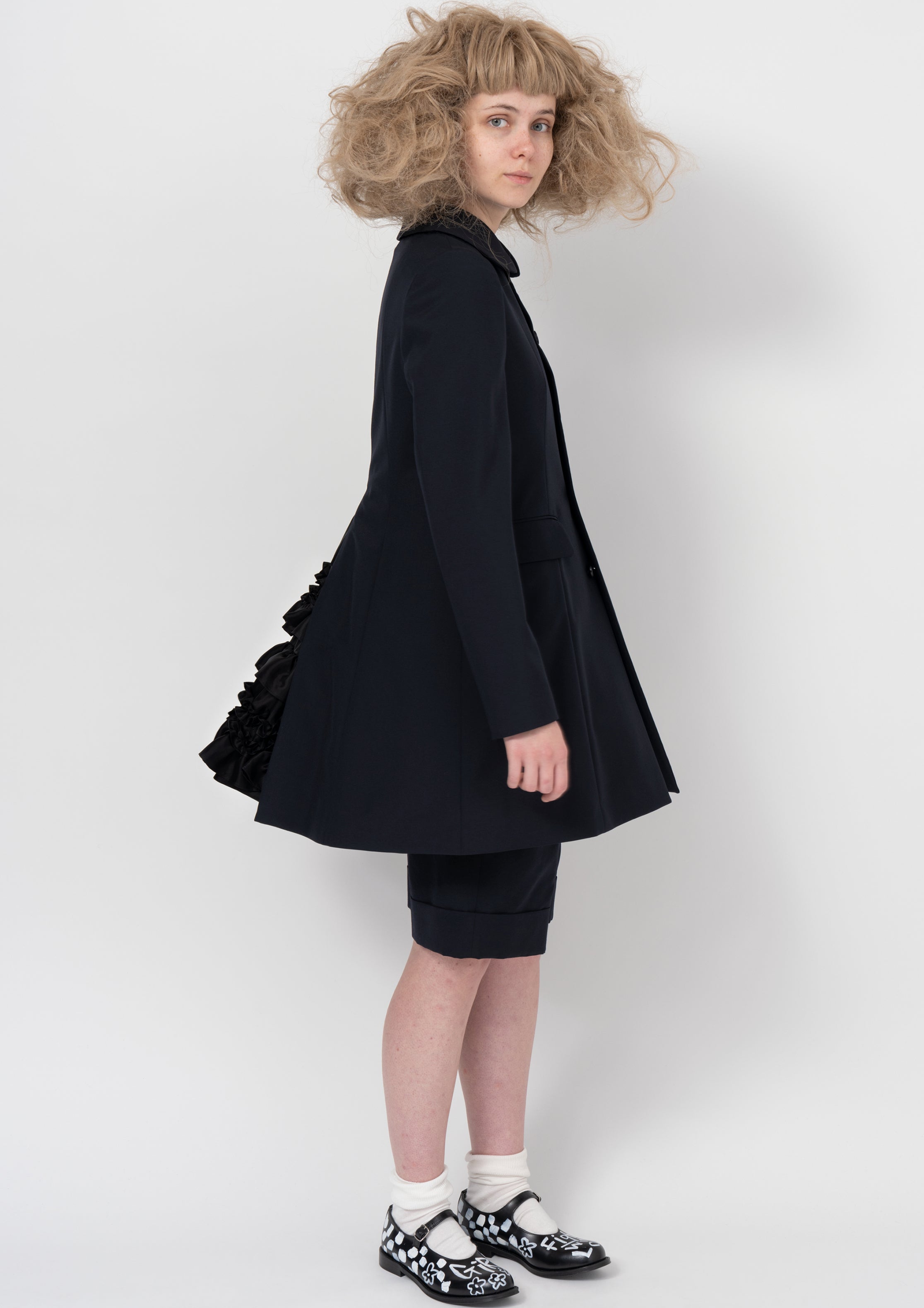 Fashion model wearing a COMME DES GARÇONS GIRL AW26 outfit
