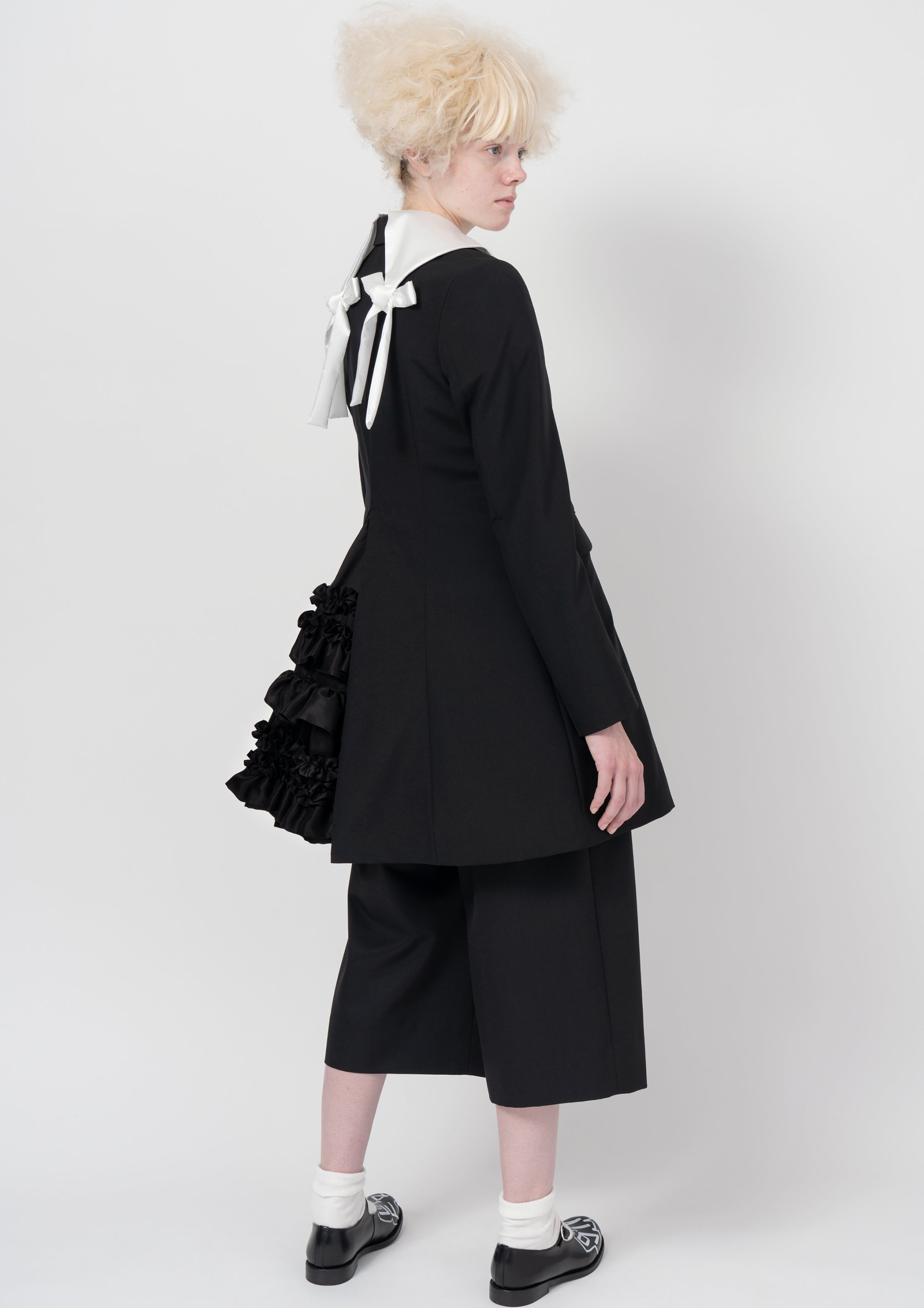 Fashion model wearing a COMME DES GARÇONS GIRL AW26 outfit