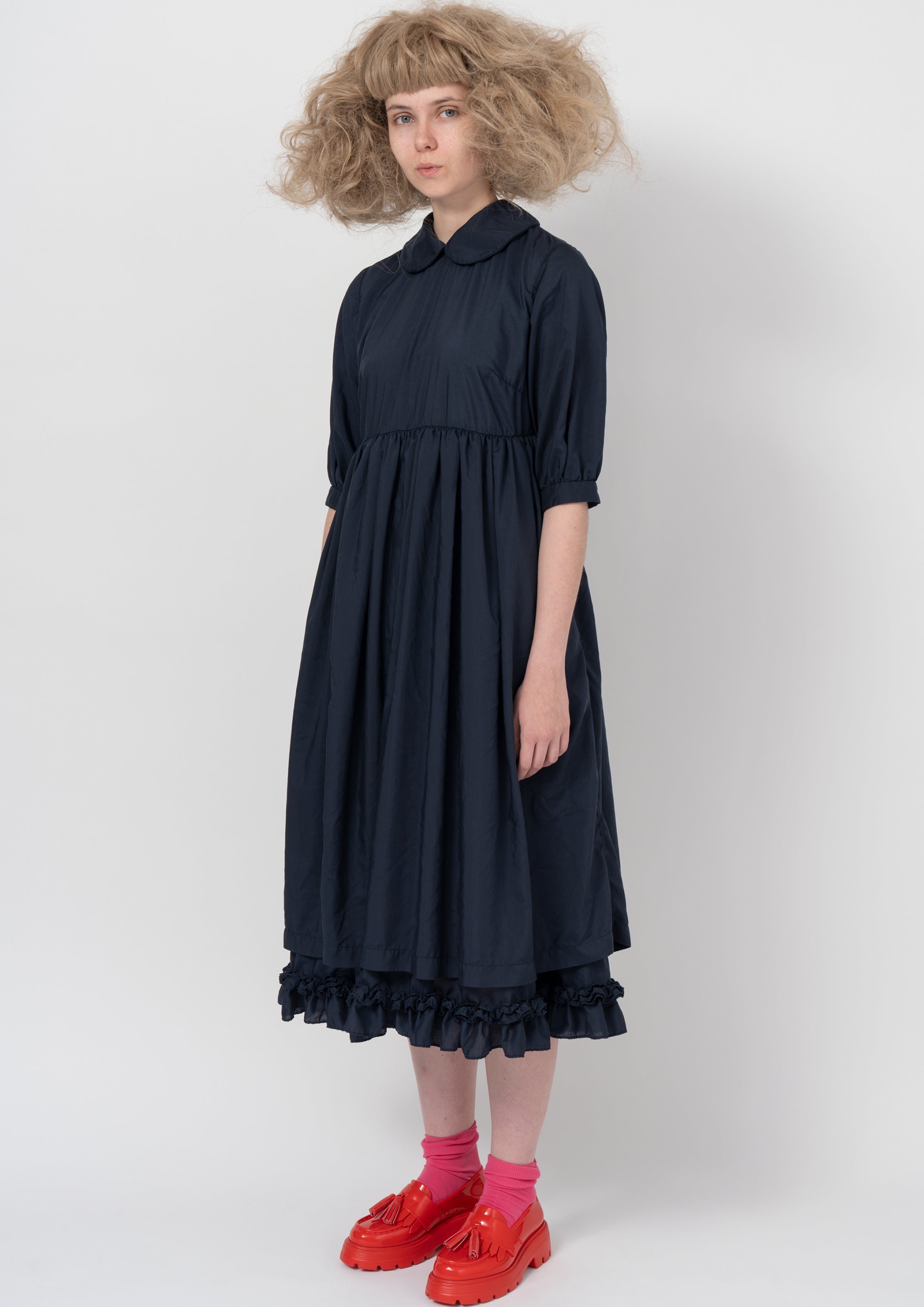 Fashion model wearing a COMME DES GARÇONS GIRL AW26 outfit