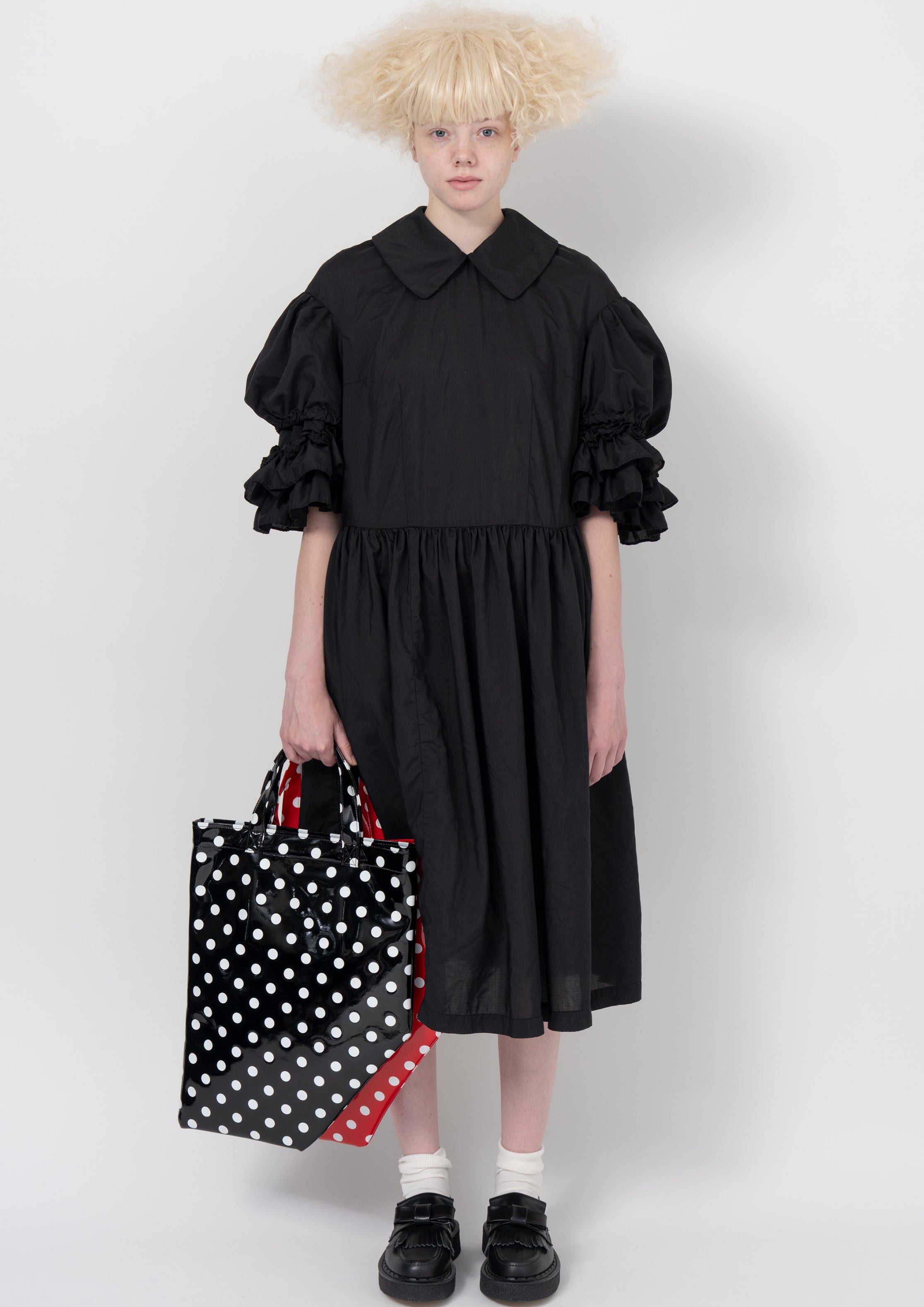Fashion model wearing a COMME DES GARÇONS GIRL AW26 outfit