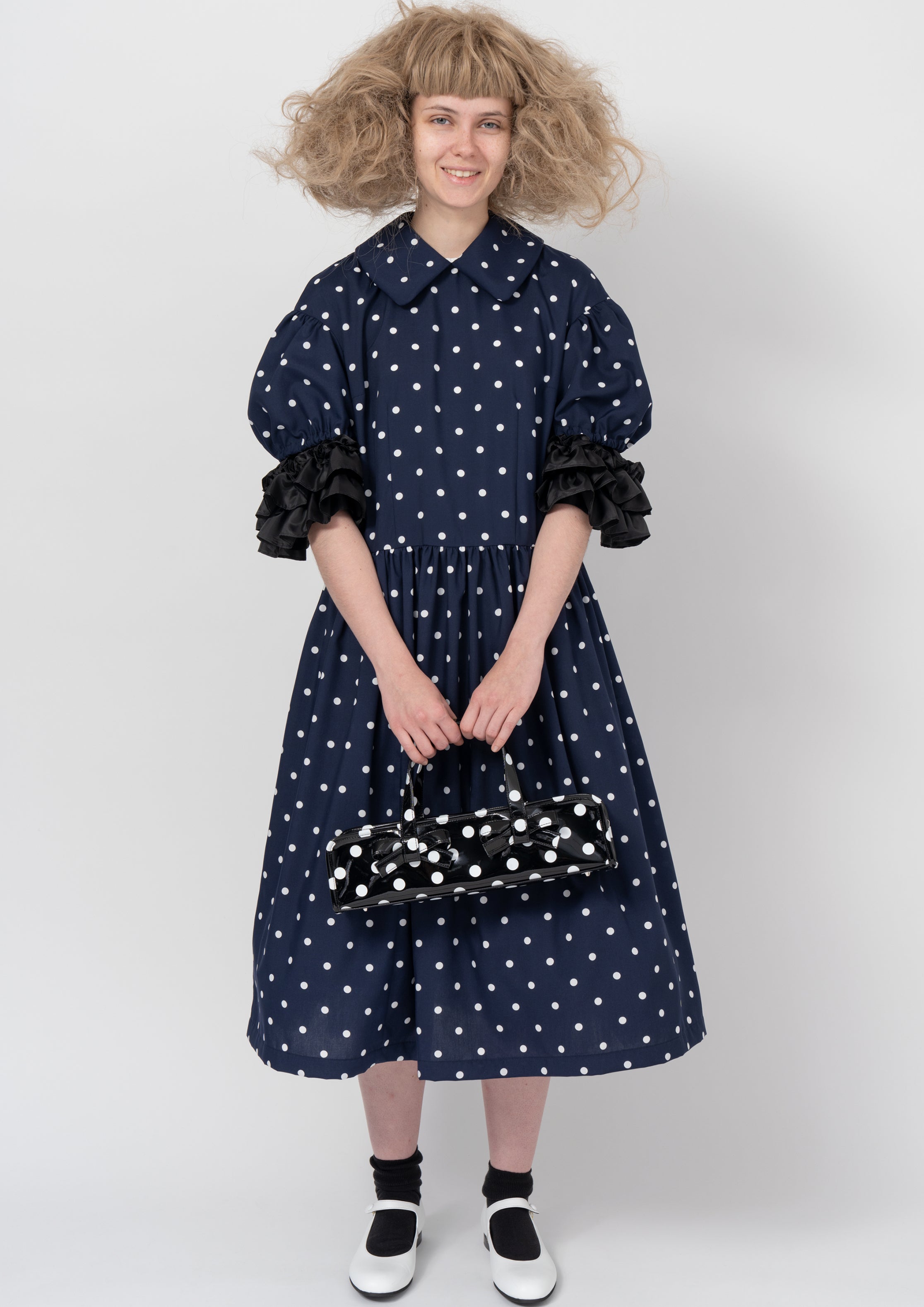 Fashion model wearing a COMME DES GARÇONS GIRL AW26 outfit