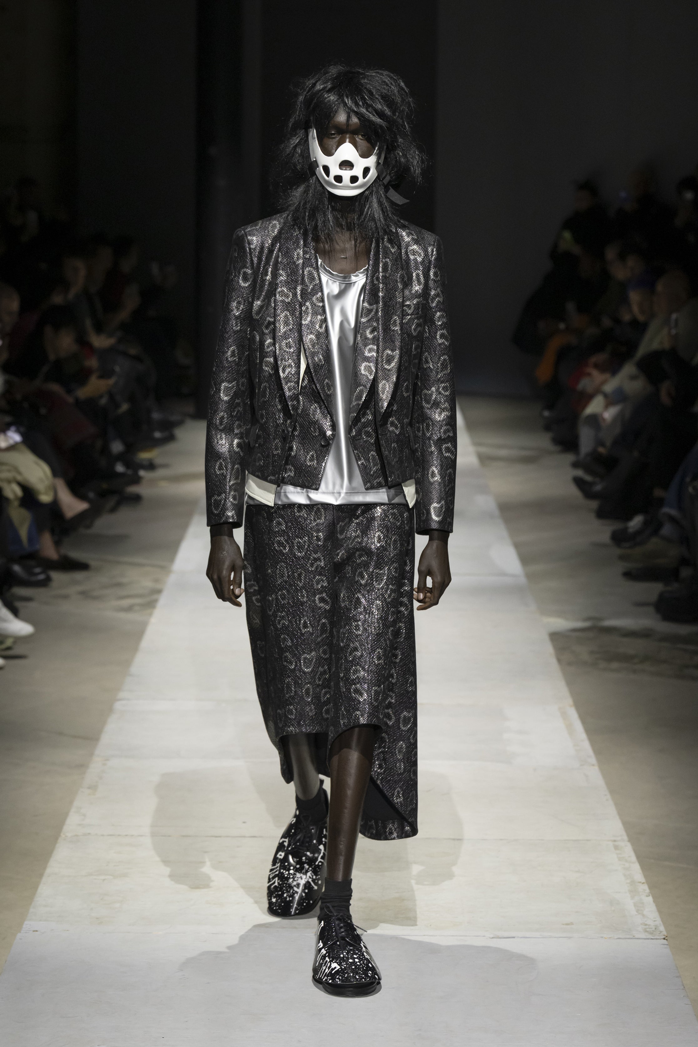 Fashion model wearing a COMME DES GARÇONS HOMME PLUS SS26 outfit