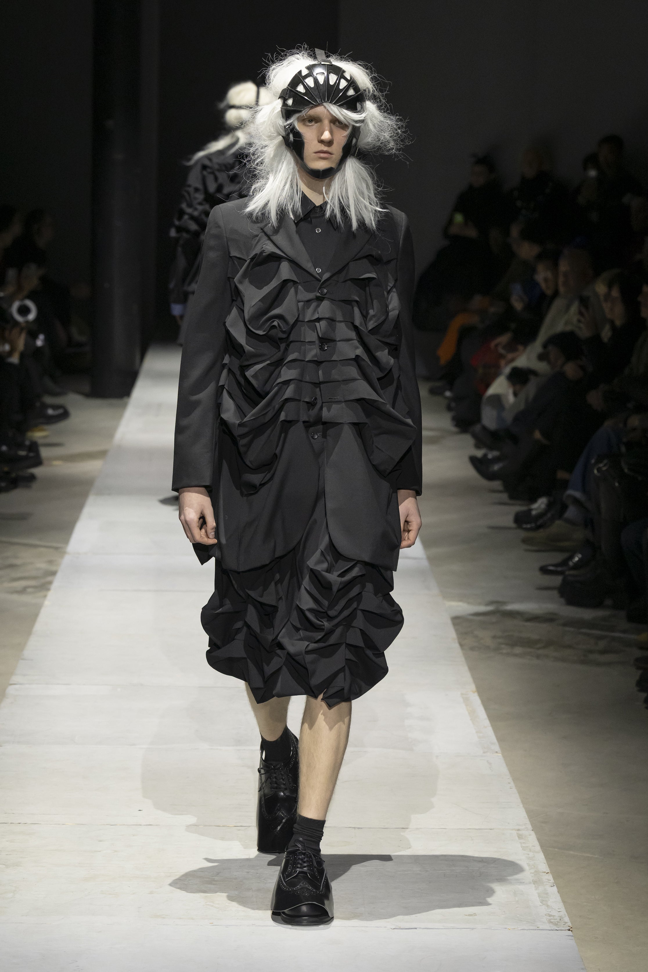 Fashion model wearing a COMME DES GARÇONS HOMME PLUS SS26 outfit