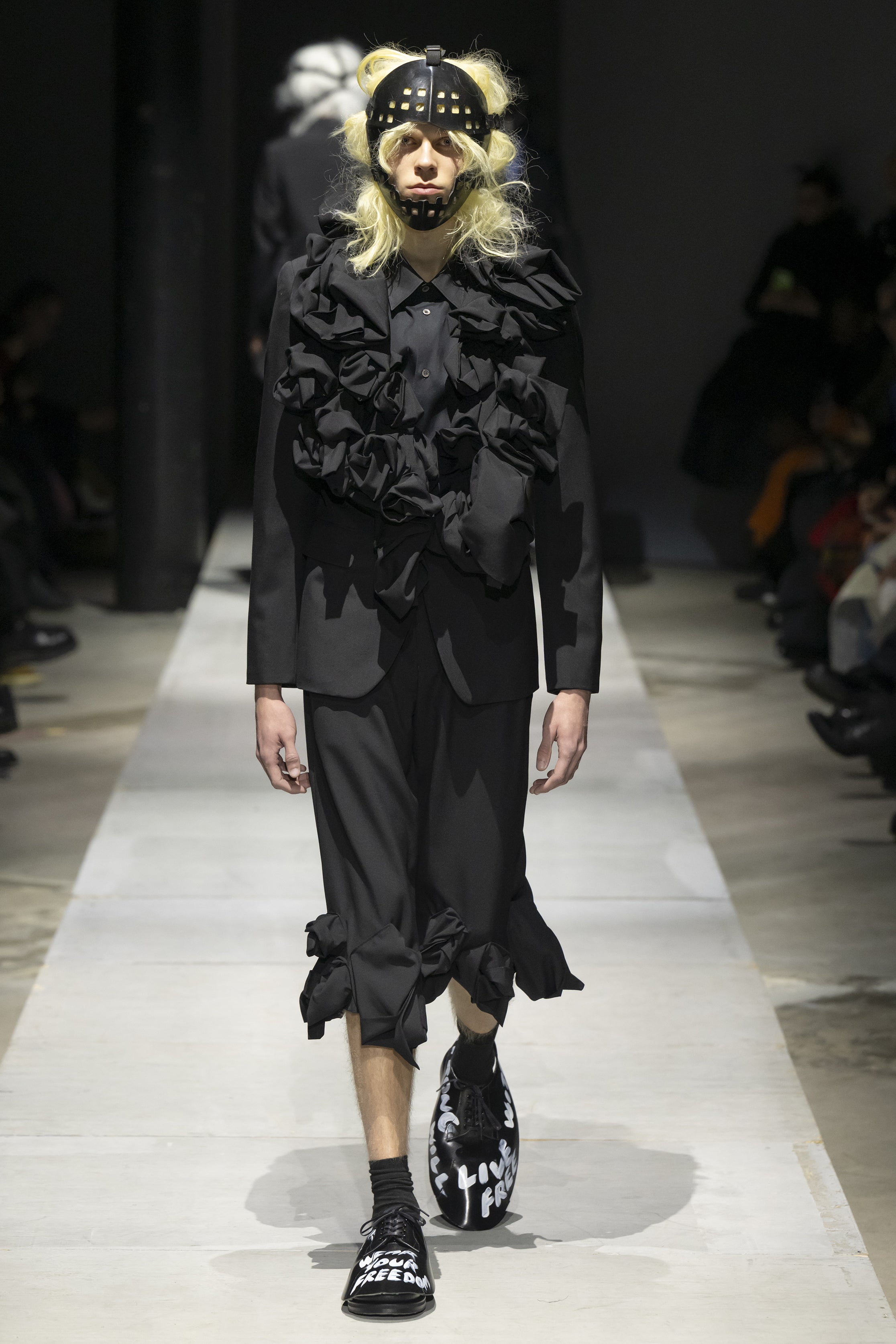 Fashion model wearing a COMME DES GARÇONS HOMME PLUS SS26 outfit
